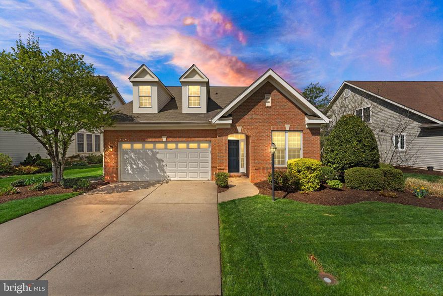 Welcome to this beautifully appointed former model home located in a desirable 55+ community! Offering two-level living, this home is perfect for those looking for luxury, comfort, and convenience. The main level features a spacious primary bedroom with a large walk-in closet and an en-suite bath, ensuring ultimate privacy and ease of access. Beautiful hardwood floors run throughout the home, enhancing the bright and open layout.

The heart of this home is the gourmet kitchen, complete with high-end appliances, custom cabinetry, and sleek granite countertops, making it perfect for both casual meals and entertaining. The great room features a cozy fireplace, ideal for relaxing evenings.

Upstairs, you'll find a versatile loft that can be used as a home office, additional living area, or guest space. 

Step outside to enjoy a patio that backs to a peaceful tree-line, offering privacy and beautiful views of nature. As a former model home, this property is filled with designer finishes and thoughtful upgrades, giving you the best of both style and functionality. For added convenience, main-level laundry and a two-car garage are also included

Access to community amenities including  clubhouse, fitness center, pool and membership availability to the golf course.