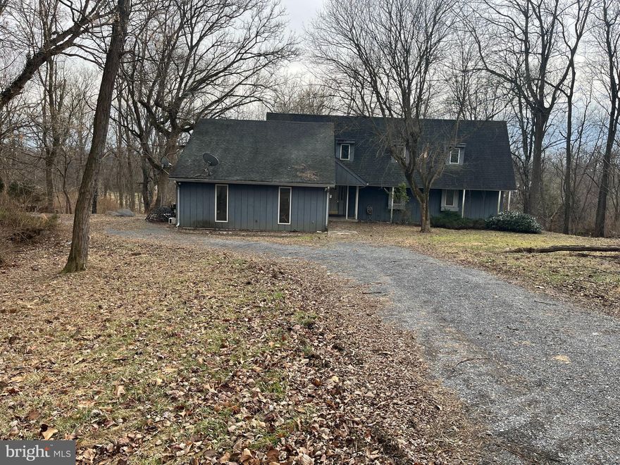 **Sellers are asking for "highest and best" by 5pm on 02/19/2025

Stunning Contemporary Home in Golf Course Community –Convenient commuter location to:  MD, VA, & DC Metro Area

This gorgeous contemporary home offers an open, airy living experience in one of the most desirable areas of the metro region. Featuring a 2-story great room with hardwood floors, a vaulted beamed ceiling, and a striking floor-to-ceiling stone fireplace, this home exudes elegance and warmth.

Three sliding glass doors lead out to a wraparound deck, ideal for entertaining or enjoying the tranquility of the private, wooded backyard. The upper level is home to two master suites, each with an attached bath and a hidden bonus room, offering versatility and ample space.

Additional features include plenty of closets and storage space and an oversized two-car garage. Located within a peaceful golf course community, this home is perfect for those who appreciate luxury living and nature.

The property does need some TLC and is being sold "AS-IS".