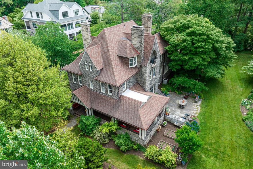 Welcome to Cheston House, built in 1890, recently restored and thoughtfully renovated by the current owners in partnership with Tallulah and Bird and Regan Construction, with incredible attention to timeless materials and stunning details.  Originally named for one of Chestnut Hill Hospital's first doctors, this stately stone, Queen Anne style home, designed by Cope & Stewardson with a later addition by Brockie & Hastings, sits on a breathtakingly landscaped, flat .78 acre lot in a wonderful "walk into town" location. It features many magnificent, original architectural designs including sun-filled leaded windows, 10 foot ceilings, gabled dormers, arched casements, massive moldings and beams, original oak floors and wainscoting, 7 fireplaces with original mantels, grand, main staircase within the side turret and an expansive covered wrap around porch leading to spacious terraces. Beautifully maintained and re-imagined, this 6 bedroom, 4 1/2 bath  residence offers a fabulous, artistically crafted new gourmet kitchen with Tallulah and Bird cabinetry, Calcutta gold marble countertops, BlueStar 48" 8-burner gas range, BlueStar refrigerator, hand-made Moroccan Zellige tile and Waterworks fixture, with endless views of the gardens and an effortless flow from each room to the next. It embraces modern living styles throughout while preserving the integrity of its original design at every turn. The expansive primary suite with sitting room, also features a fully renovated vintage-style white marble bath with soaking tub and oversized frameless glass shower.  Surrounding gardens, full of specimen plantings, were featured on the 2006 Historical Society tour. This treasure is majestically located on a coveted corner of one of Chestnut Hill's most prestigious streets, within an easy walking distance to the park, wonderful shops, restaurants, trains and more. Move right in and enjoy!