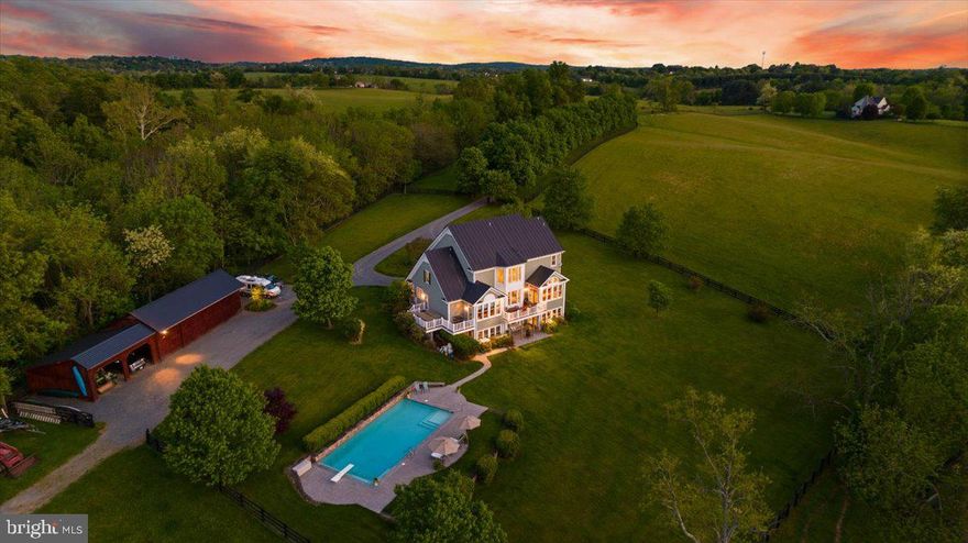 Welcome to your very own slice of heaven in historic Waterford, where luxury meets country living! This stunning dream property spans over 55 acres of picturesque rolling hills, woods, and fields, complete with a meandering stream that adds to the natural beauty of the surroundings. Perfect for horse enthusiasts, the property boasts 4 large paddocks, pasture, hay field, and 4 board wood fencing.

This magnificent listing offers the best of both worlds- the privacy and tranquility of serene rural surroundings, while still being just minutes away from the charming towns of Leesburg and Lucketts, as well as local vineyards and breweries. The beautiful home is a masterpiece of design and architecture, with a stately exterior that boasts multiple decks, a patio, and a stone front porch that will take your breath away.

Step inside to find a beautifully designed interior with hardwood floors throughout the main level and tile floors in the charming farmhouse-inspired kitchen. The chef's kitchen is equipped with ample cabinetry, a center island, and a farm sink, and features a breakfast area in a beautiful morning room that is the perfect spot to enjoy a cup of coffee. The main level also includes a 2-story family room with a stone fireplace, a dining room to host dinners, a library with built-in bookshelves, and a primary bedroom with a bathroom that features exterior access to a deck with a hot tub. With windows galore, natural light and stunning views of the property are never in short supply.

The fully finished walk-out lower level includes another bedroom with a full bathroom, an additional full bathroom for convenient changing when your enjoying the 20x40 pool, a workout room, and a large recreational room with a wet bar and ample storage space. Perfect for horse owners, the 4-stall horse barn includes a tack room, wash stall, and hay loft, making caring for your horses a breeze. The 50x25 combined garage and workshop is timber-framed and features 4 large bays, with an additional 25x25 covered 2 bay area for equipment and toys.

Don't miss out on the opportunity to make this stunning property your own!