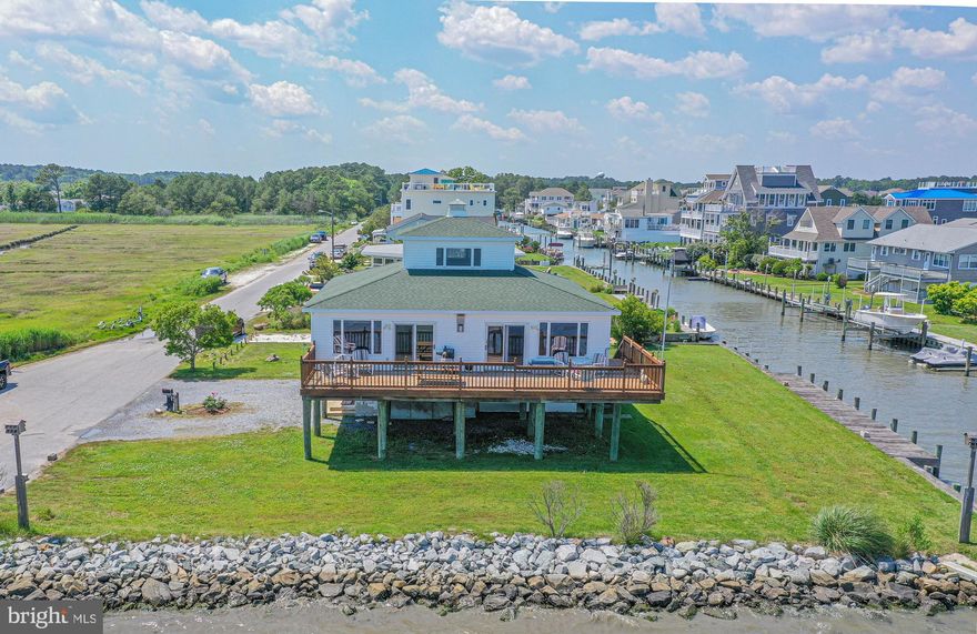 WOW! Rare Find-Custom built direct bayfront home overlooking the Sinepuxent Bay, Assateague Island, and the Atlantic Ocean!! This unique home designed to resemble the Chesapeake Bay lighthouse features a large bayfront deck, boat dock, boat ramp and extra large lot!! Interior features include, water views from every window, spacious open floor plan, 2 large bedrooms on the main floor and a loft with spectacular 360 degree panoramic views could be used as a 3rd Bedroom. HVAC and roof have recently been replaced. (( Sewer fee $328 per Quater )  Located in the picturesque, tranquil, neighborhood of Snug Harbor within 5 miles of Assateague and just 3.1 miles from the OC inlet with no bridges- You’ll enjoy majestic moonrises, sunrises, rainbows, nature views, boating, fishing, water sports and all of the nearby amenities of Assateague State & National parks (home of the wild ponies), Ocean City beaches and boardwalk, world-class golf courses, family and fine dining, amusement parks and main street Berlin, (voted Coolest Small Town in America)! No City Taxes and HOA is voluntary for just $40 annually!
