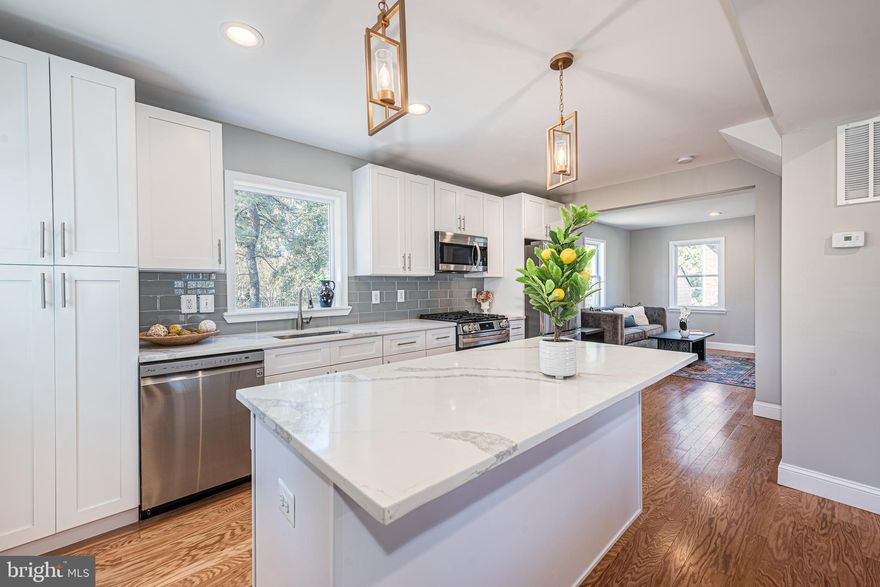 GRACIOUS AND ELEGANT RENOVATED COLONIAL WITH AN IMPRESSIVE ARRAY OF AMENITIES!   Features include wood flooring throughout the main level, an inviting living room with a wood fireplace, separate dining area, a designer island kitchen with attractive white cabinetry, Quartz counters, & ss appliances, a generously sized Primary bedroom suite with a full bath, and 2 additional bedrooms with a hall bath on the upper level, a finished basement with a family room and an additional bedroom suite with a full bath, a spacious rear yard that's perfect for entertaining, and driveway parking for multiple cars.  Located in the desirable Rodger's Forge neighborhood - close to schools, restaurants, shopping, and St. Joseph's Medical Center.  This one has it all!