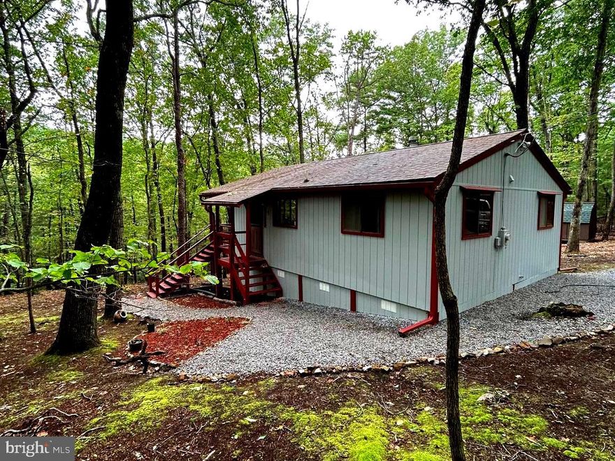 Just relisted, was temporarily off market while seller was on vacation. 

Escape to almost heaven in the WV mountains! Beautiful home very meticulously cared for and comes with 3.3 acres. Come make this home your own in this wonderful community with hiking trails, pavilion, soft ball field and community lake for kayaking, canoeing, tubing, paddle boarding, fishing, etc. Huge private deck, enjoy the peace and quiet, wildlife included. Great location and easy access. Could also be a great investment property or vacation home. Close to the Woods Resort Golfing and Spa, C&O Canal, Potomac River, Sleepy Creek Forest Reserve with 200-acre lake and hunting grounds, under 30 minutes from Berkeley Springs, and close to shopping. This home is turnkey and has many upgrades. Newer roof recently sealed, new gutters, new water filtration system, new fireplace insert, chimney, beautiful new flooring, and crawl space was just redone with all new skirting insulation and vapor barrier, deck redone too. Must see before it's gone. Could be a great rental or Air B&B. Motivated Seller. Come make an offer.