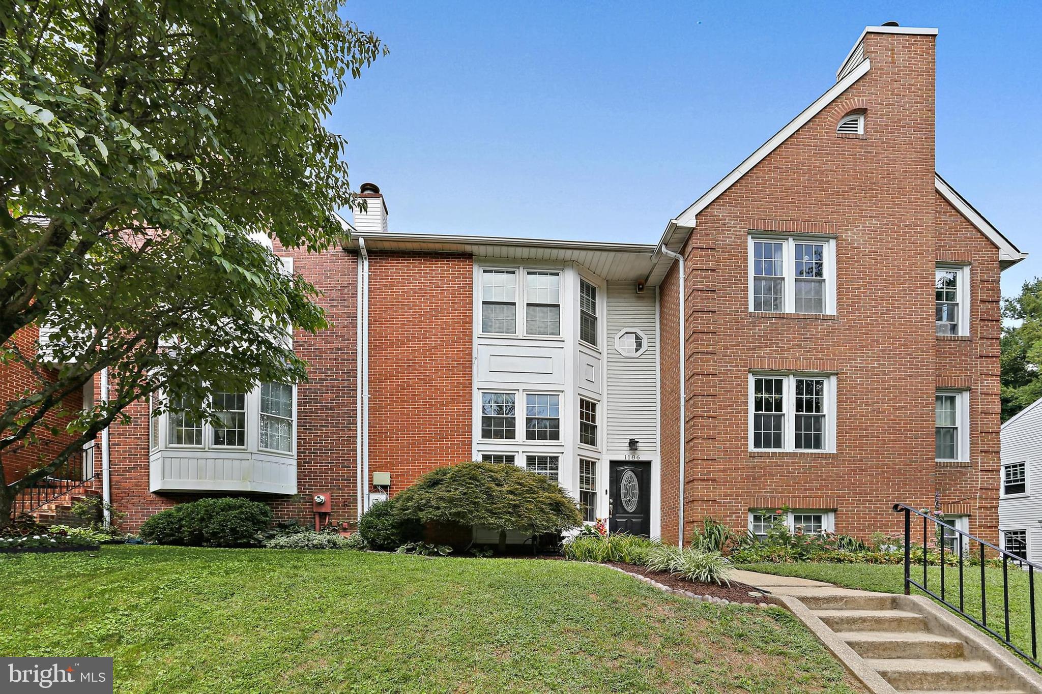 This beautifully updated townhome stands out from the rest with its spacious, open floorplan and exceptional kitchen. Designed for both style and function, the kitchen offers modern white cabinetry, upgraded counters, newer stainless steel appliances, and an abundance of storage, far more than typically found in nearby homes, along with generous workspace for cooking and entertaining. Hardwood floors flow throughout the main level, while the living room’s cathedral ceilings create an airy, open feel. Every floor features an updated bathroom. Major improvements in recent years include a complete kitchen renovation (2020), attic fan, replacement windows and doors, upgraded ductwork, neutral carpet, and both the roof and HVAC systems have been replaced in 2025. The walkout lower level includes a spacious family room, even more storage, a second half bath, a separate laundry area, and direct access to the outdoor space.