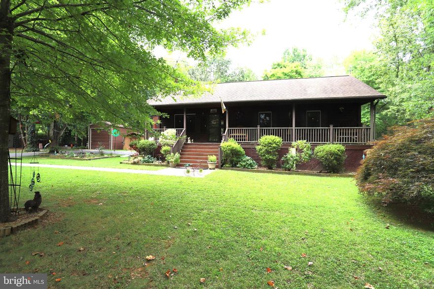 Huge Price Adjustment! Cozy Country Retreat!  Nestled on 3 private, park-like acres of mature plantings and trees is this lovely 3 Bed/2 Bath Rambler.  Home offers a very efficient floor plan, tile and hardwood floors in the common areas, separate kitchen and dining rooms, and large living room with electric fireplace.  Electric blinds in bedrooms. Full unfinished basement with wood stove and extra fridge and freezer.  Covered front, rear and side porches, partial board and privacy fencing, dog kennel, large detached garage/shop with oversized door, numerous sheds, screened gazebo and so much more.  All conveniently situated close to Louisa, Gordonsville, Orange, RTs 33, 64 and 15, Lake Anna and the list goes on.  Don't miss the secure and stylish gated entrance and cute koi pond with waterfall!