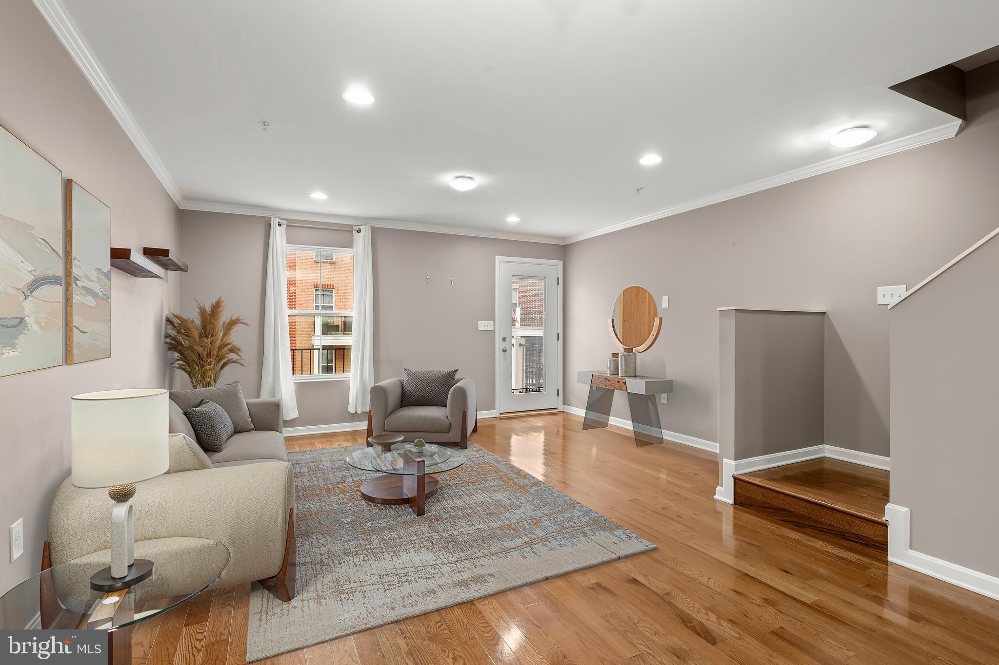 >> Immediate Availability << Introducing a contemporary 3-bedroom, 3.5-bath townhome in the highly sought-after Athena Square neighborhood, ideally situated where Canton, Greektown, and Brewers Hill intersect.
This four-level residence is designed for modern living, combining style, functionality, and abundant natural light. The main living area features gleaming hardwood floors, recessed lighting, and elegant crown molding, creating a bright and welcoming atmosphere. The gourmet kitchen is a centerpiece for entertaining, complete with a large center island, granite countertops, 42” cabinetry, pantry, and stainless steel appliances, including gas cooking and a range hood. From the living room, step onto your private balcony to catch the beautiful sunrise.  The powder room on this level adds convenience for guests.
The upper level is home to the primary bedroom suite, featuring a private en suite bath and double closets, including a walk-in. A second en suite bedroom with dual entry bath ensures flexibility and comfort. The top level includes a third en suite bedroom and a bright sitting room; ideal as an office with access to the rooftop deck, delivering sweeping city skyline vistas.
Additional thoughtful touches include a generous entry-level garage, simplifying daily routines. 
Residents enjoy proximity to Patterson Park, one of Baltimore’s largest parks, offering sports fields, playgrounds, and scenic walking paths. The surrounding neighborhoods feature boutique shops, specialty markets, and dining options, while Greektown hosts an annual festival celebrating Greek culture, food, and music. Commuters benefit from easy access to I-95, Eastern Avenue, Route 40, and Boston Street, connecting you seamlessly to destinations near and far. Experience contemporary living and vibrant city life in this exceptional Athena Square townhome.
Note:  Select interior photos have been virtually staged.