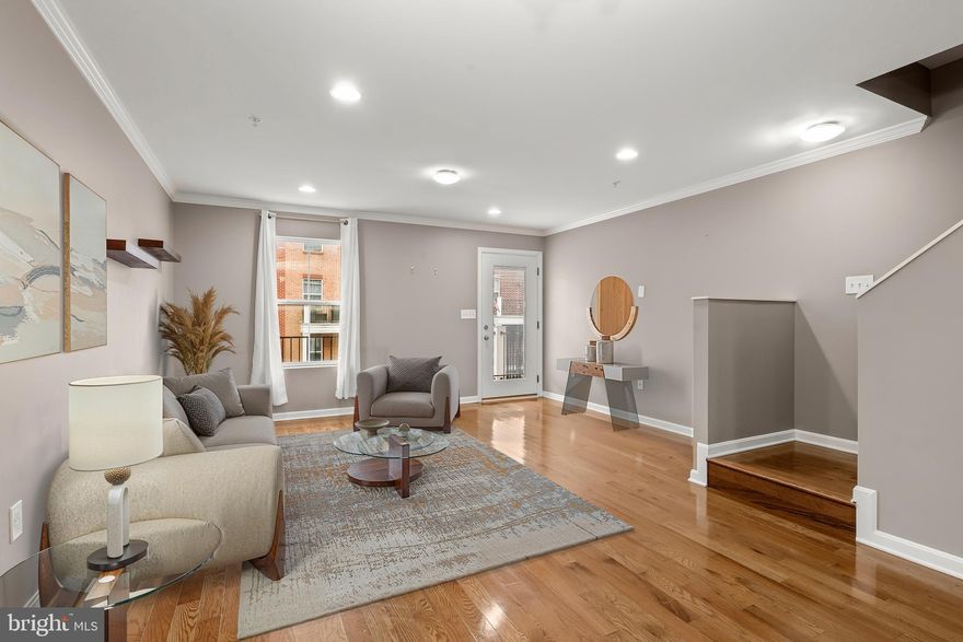 >> Immediate Availability << Introducing a contemporary 3-bedroom, 3.5-bath townhome in the highly sought-after Athena Square neighborhood, ideally situated where Canton, Greektown, and Brewers Hill intersect.
This four-level residence is designed for modern living, combining style, functionality, and abundant natural light. The main living area features gleaming hardwood floors, recessed lighting, and elegant crown molding, creating a bright and welcoming atmosphere. The gourmet kitchen is a centerpiece for entertaining, complete with a large center island, granite countertops, 42” cabinetry, pantry, and stainless steel appliances, including gas cooking and a range hood. From the living room, step onto your private balcony to catch the beautiful sunrise.  The powder room on this level adds convenience for guests.
The upper level is home to the primary bedroom suite, featuring a private en suite bath and double closets, including a walk-in. A second en suite bedroom with dual entry bath ensures flexibility and comfort. The top level includes a third en suite bedroom and a bright sitting room; ideal as an office with access to the rooftop deck, delivering sweeping city skyline vistas.
Additional thoughtful touches include a generous entry-level garage, simplifying daily routines. 
Residents enjoy proximity to Patterson Park, one of Baltimore’s largest parks, offering sports fields, playgrounds, and scenic walking paths. The surrounding neighborhoods feature boutique shops, specialty markets, and dining options, while Greektown hosts an annual festival celebrating Greek culture, food, and music. Commuters benefit from easy access to I-95, Eastern Avenue, Route 40, and Boston Street, connecting you seamlessly to destinations near and far. Experience contemporary living and vibrant city life in this exceptional Athena Square townhome.
Note:  Select interior photos have been virtually staged.