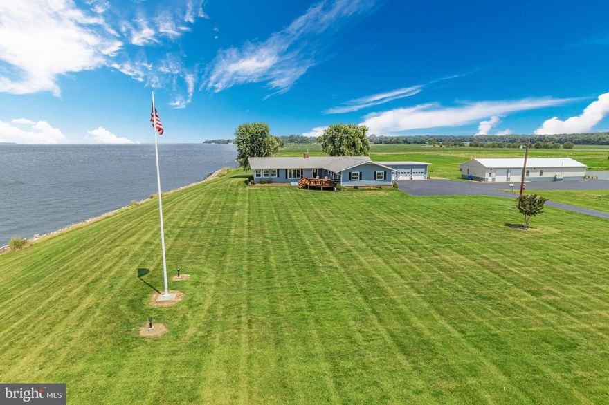 Nestled upon a picturesque 10-acre expanse along the tranquil shores of the Chesapeake Bay, this waterfront home epitomizes coastal luxury and serenity. As you approach the property, a long driveway bordered by lush vegetation  welcomes you to this secluded oasis. The newly painted and newly carpeted Main House Grandfathered on the waters edge pays homage to the coastal locale, with gorgeous views of the bay, The home/property offers a pole barn, currently being used a additional large living space with a kitchenette, a guest suite with thermostatic controlled heat and water, a shed for tools and supplies and a very large pond serviced by a well allowing for excellent waterfowl habitat or simply enjoy canoeing around for pleasure. Gliding Gander offers an additional detached heated garage with a bathroom, perfect for an office or studio. a backup generator, and a shoreline fully rip-rapped and with an attractive riparian buffer on the balance. 
The main residence, a stunning blend of ranch style architecture and classic coastal charm, commands breathtaking views of the shimmering waters. Its expansive windows and spacious rooms invite the bay's gentle breeze and golden sunlight into every corner. Stepping inside, you are greeted on the right, a handsome library to enjoy reading your favorite book of the Eastern Shore as you look out to the water, an open kitchen and dining area provides the atmosphere of refined sophistication. Off the dining area you are welcomed into the living room with views of the bay adorned with a crackling fireplace which  provides the perfect space for relaxation and entertaining, while large glass sliding doors beckon you to step outside and embrace the waterfront lifestyle. Also off the family room leads into the the sun room surrounded by large windows where one can enjoy their morning coffee or relax and take in the sunset, while enjoying the views of boats, birds and fish jumping. Or take pleasure going out to the newly refurbished deck. The main house is complete with one level living with 3 bedrooms - 3 full baths, a lower level with outdoor access and tons of storage just under 3,000 SqFt. Additionally, the home offers 2 heat pumps and the cast iron baseboards are operated with an oil fired boiler. ALL BRAND NEW FURNITURE CONVEYS. 
Located just outside of Rock Hall city limits. In the distance your view is the Baltimore skyline. Floor plans are available under documents. THIS IS A MUST SEE!