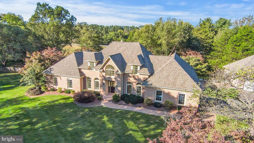 Stately Brick Colonial on a gorgeous lot in Great Falls.  Located on a quiet, no-thru street on a 1.73 acre lot, this 6400+ sq ft home offers timeless curb appeal in serene surroundings. The meticulously manicured grounds feature lush lawns, mature plantings, and cascading waterfall features that create a peaceful, picturesque setting.
What makes this home unique is that the spacious primary suite is located on the main level of the home. This private retreat has two walk-in closets, a luxurious oversized en-suite bath, a sitting area with gas fireplace and a sleeping area.  The floorplan also features formal and casual living and dining areas, a home office, powder room, mudroom and butlers pantry.  The floor plan also features multiple patios ideal for entertaining or relaxing, and a rare combination of an attached two-car garage plus a detached two-car garage—perfect for car enthusiasts or extra storage.
The lower level is a true retreat, complete with a fitness center, sauna, jacuzzi, and walk out rec room. There is a separate bedroom, bathroom and sitting room en suite with its own walk-out to a private lower patio— offering flexibility for extended stays or additional private living space.
On the top floor, two generously sized bedrooms each have their own private bathrooms. Recent updates include a newer roof and gutters (2019). The home was freshly painted in 2025, and there is new carpeting the primary suite, and new hardwoods in the living room, family room and dining room.   
The expansive kitchen, while functional, is ready for a modern transformation—custom renovation plans by a local design build firm will be available during the open houses to give the next owner a head start in creating their dream culinary space. There is  no need to add onto this home, just.  Colonial on a gorgeous lot in Great Falls.   Located on a quiet, no-thru street on a 1.73 acre lot, this custom brick colonial offers timeless curb appeal, serene surroundings, and exceptional space inside and out. The meticulously manicured grounds feature lush lawns, mature plantings, and cascading waterfall features that create a peaceful, picturesque setting.
What makes this home unique is that a spacious primary suite is located on the main level of the home. This private retreat has two walk-in closets, a luxurious oversized en-suite bath, a sitting area with a gas fireplace and a sleeping area.  The floorplan also features formal and casual living and dining areas, a home office, powder room, mudroom and butlers pantry.  Multiple patios are ideal for entertaining or relaxing, and a rare combination of an attached two-car garage plus a detached two-car garage is perfect for car enthusiasts or extra storage.
The lower level is a true retreat, complete with a fitness center, sauna, jacuzzi, and walk out rec room. There is a separate bedroom, bathroom and sitting room en suite with its own walk-out to a private lower patio— offering flexibility for extended stays or additional private living space.
On the top floor, two generously sized bedrooms each have their own private bathrooms. Recent updates include a newer roof and gutters (2019). The home was freshly painted in 2025, and there is new carpeting in the primary suite, and new hardwoods in the living room, family room and dining room.   
The expansive kitchen, while functional, is ready for a modern transformation—custom renovation plans by a local design build firm will be available during the open houses to give the next owner a head start in creating their dream culinary space. There is  no need to add onto this home, just re-imagine the existing space and customize to your liking.
This is a rare opportunity to own a distinguished home with incredible bones, beautiful views from every window, and exceptional potential—all in an idyllic Great Falls location. Schools include Forestville Elementary, Cooper Middle School and Langley High S