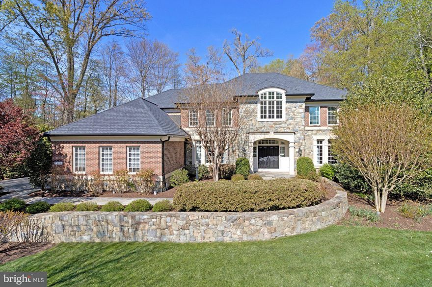 This beautifully crafted stone and brick colonial in the highly sought-after Reserve is ideally sited on a quiet cul-de-sac, backing to trees and surrounded by lush landscaping for a serene and private setting. Thoughtfully renovated and meticulously updated, the home offers over 8,000 square feet of refined living space with six bedrooms, 5.5 baths, and exceptional flexibility for everyday living, working, and entertaining.

A welcoming two-story foyer with a soaring ceiling and gracefully curved staircase sets the tone, offering a stunning sightline through the great room to a dramatic wall of windows overlooking the backyard. Natural light fills every room, enhancing the home’s open and flowing floor plan. The foyer is flanked by elegant formal living and dining rooms, while the great room serves as a striking focal point with bay windows and a gas fireplace. A sunroom with a vaulted ceiling provides a bright and inviting retreat, and the private library features built-ins and peaceful views of the grounds.

The gourmet kitchen has been completely renovated with exceptional attention to detail, featuring a large center island, quartz countertops, and premium Wolf and Sub-Zero appliances. A breakfast bar, walk-in pantry, mudroom, laundry room, and access to the three-car garage complete the main level.

Upstairs, the impressive owner’s suite offers a true sanctuary with a beautifully renovated luxury bath and two spacious walk-in closets with custom systems. Four additional bedrooms include two en suites, and all bathrooms have been thoughtfully updated.

The walk-up lower level is designed for entertaining, offering a spacious recreation room with engineered hardwood flooring, a billiards area, and a custom mahogany bar equipped with a microwave, mini-fridge, drawer dishwasher, and sink. A hobby room with extensive cabinetry, an additional bedroom with a fully renovated bath, and two large storage rooms with potential for future exercise or media spaces add to the home’s versatility.

Outdoor living is equally exceptional, with a fully fenced backyard featuring a stunning stone patio with a fireplace, stacked stone walls, flagstone pathways, and extensive landscaping enhanced by landscape lighting. The setting is both private and inviting, ideal for gatherings or quiet relaxation.

Residents of the Reserve enjoy an exceptional lifestyle with amenities that include roaming security, concierge services, lawn maintenance, and community events. The location offers convenient access to top-rated schools in the Langley pyramid, Tysons, the Silver Line Metro, the Dulles Tech Corridor, and Washington, D.C., as well as nearby parks, trails, and recreational facilities.

The current owners have invested over $450,000 in recent improvements, including a new premium CertainTeed Grand Manor roof, new gutters and guards, updated HVAC systems, a whole-house generator, enhanced insulation, EV charging capability, extensive hardscaping and
landscaping, irrigation system upgrades, and numerous interior renovations throughout. A rare opportunity to enjoy a beautifully updated home in one of the area’s most desirable communities.