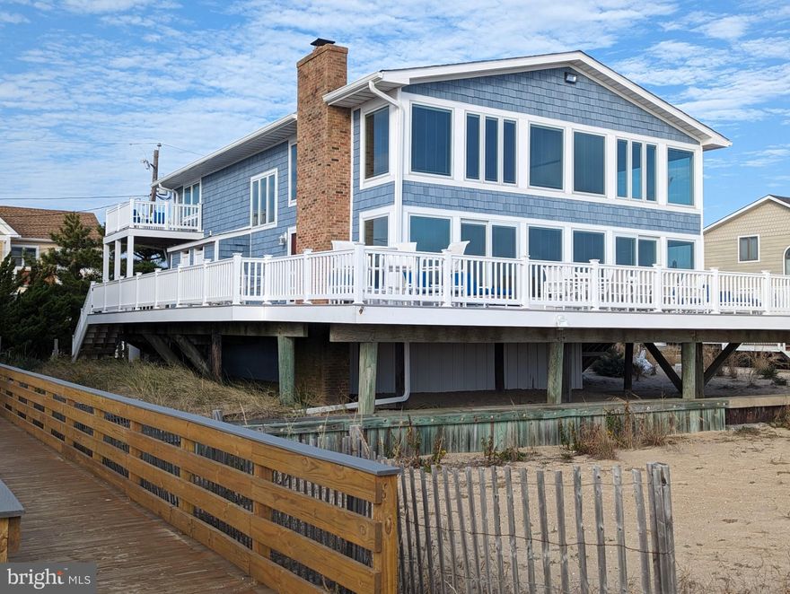 Spectacular panoramic view of the ocean. Classic Ocean Front Beach home built on a large double lot in beautiful South Bethany Beach. Abundant outdoor and indoor space for everyone! Features a huge wrap around deck and multi-level gathering areas plus no waiting to rinse off with 2 outdoor showers. Five spacious bedrooms plus a ground level bedroom. Five full baths, including an oversized luxury primary suite bath with a large sunken tub. Large kitchen with plenty of island space and countertop seating. Dining area with coffered ceiling and wonderful view of the beach. Bright open living area with stone fireplace. Attached garage with private off-street parking. Recent updates include a new roof, Pella windows, "NuCedar®" siding, 3 updated bathrooms with heated floors, "Trex" style decking and railings, new water heaters, and water flow monitoring with remote cut-off. You're literally on the beach with this wonderful home where putting your toes in the sand is just outside your door!