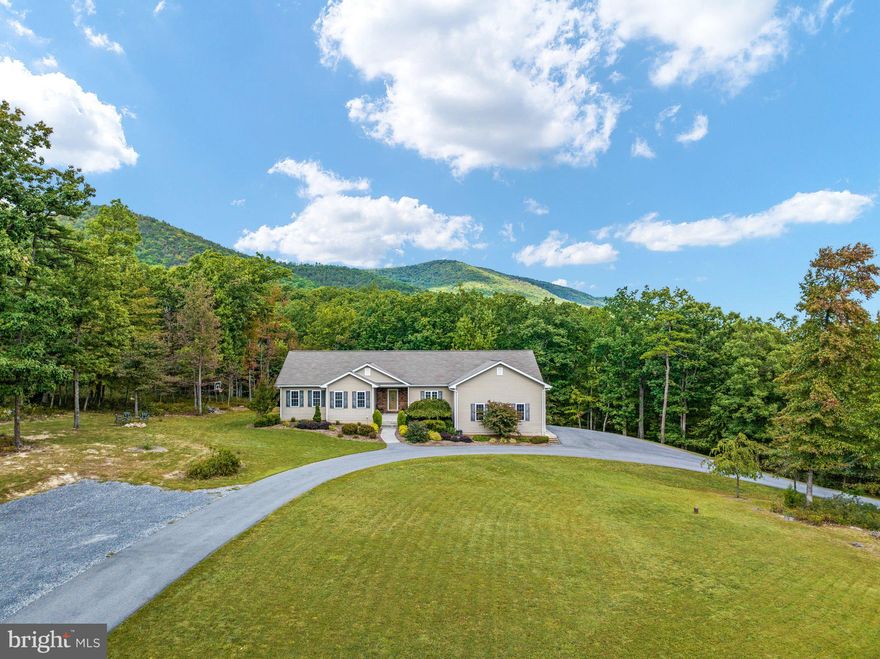 If you're looking for privacy and beauty, this is it!  Spacious home situated on 2.87 acres just 50 feet from George Washington National Forest!  Main level is light and bright with hardwood floors throughout.  Kitchen offers stainless steel appliances, granite countertops, tons of cabinet space, and bar seating.  Living room features vaulted ceilings and a woodstove for those cold winter days.  3 bedrooms and 2 full bathrooms, plus a large laundry room with an extra fridge and shelves to convey.  Screened porch is amazing!  On the lower level, you will find a den with kitchenette and flue for woodstove, 4th bedroom, full bathroom, and storage area.  There are also several other bonus rooms that could be used as an office, playroom, hobby room, exercise room, or additional bedrooms!  Paved circular driveway, two car garage, plus an RV/boat parking area provide plenty of space for you and your guests to park.  This secluded move-in ready home won't last long!  Schedule your tour today!