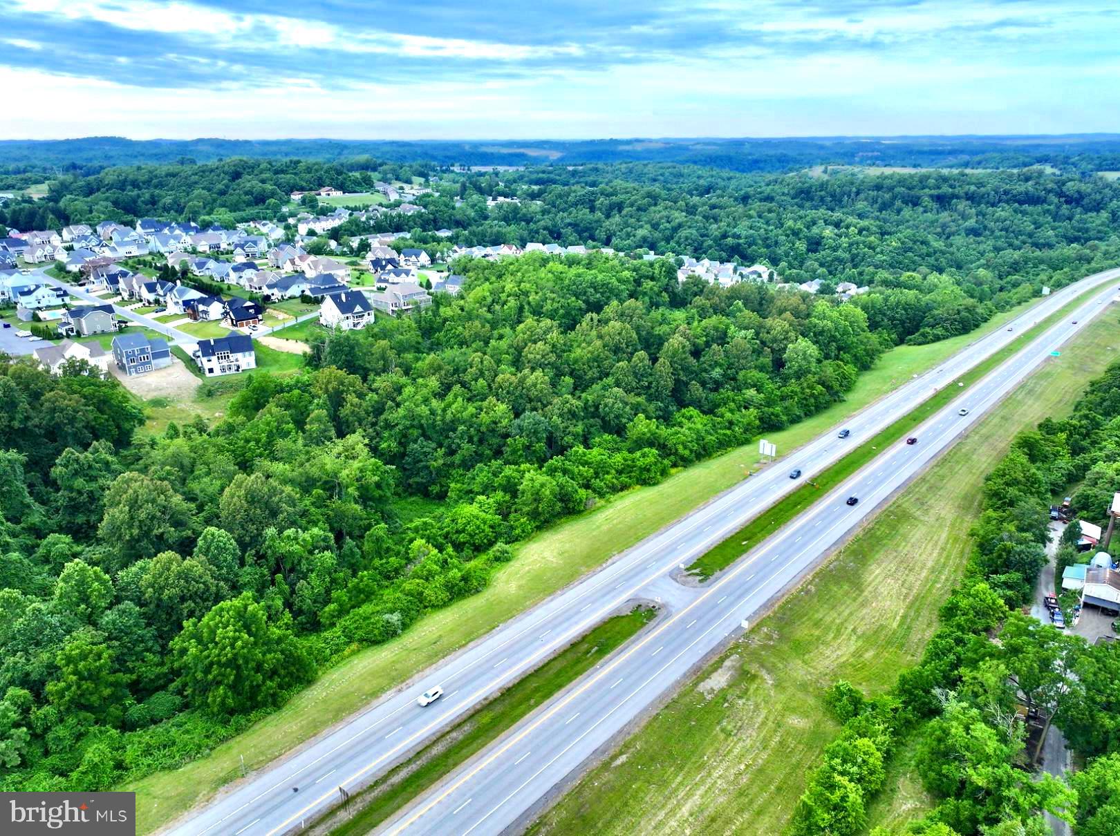 INCREDIBLE OPPORTUNITY.. 15 +/- ACRES along Interstate 68 just above Cheat Lake in Morgantown, WV! Surrounded by West Virginia mountains and just above one of WV most popular lakes. Multiple businesses & residential developments surround the property. Capabilities of two billboards in great locations on I-68. Mostly wooded with a mix of mature timber. Access off of Canyon Road. Residential, Commercial, or Recreation possibilities. Minutes to Cheat Lake, WVU, Hospitals, and all Morgantown has to offer. 30 +/- miles to Deep Creek Lake. Call today for your private showing!