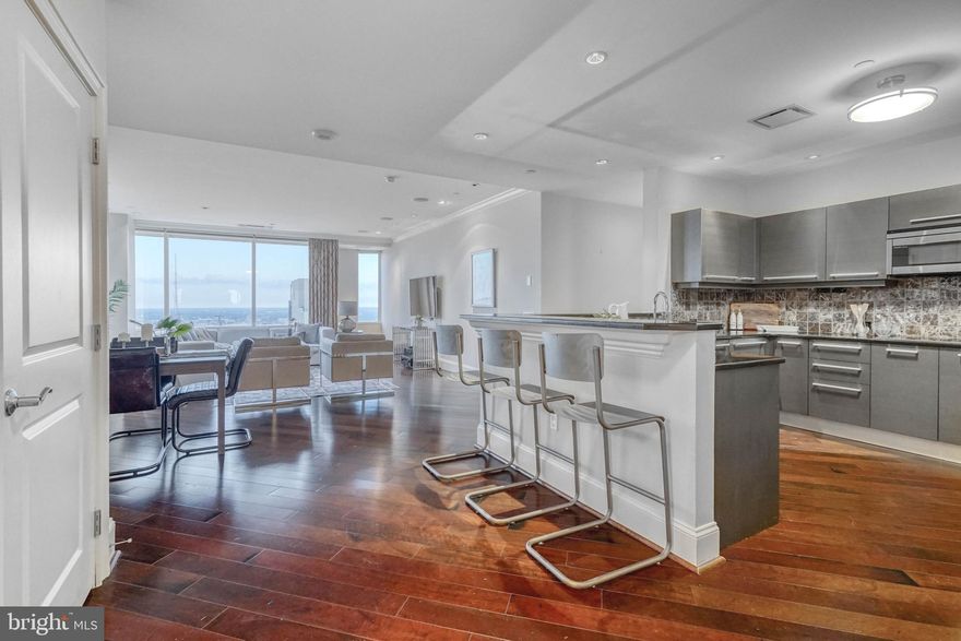 Unit #4308, located within the prestigious Residences at Two Liberty Place, is your chance to own a piece of Philadelphia's iconic skyline. This spectacular 2,350 sqft corner condo offers 3 bedroom suites, 3.5 total bathrooms, a study, and mesmerizing views from every room! Building amenities include a welcome desk staffed 24/7, valet parking, a chauffeur, concierge services, a fitness center, a yoga studio, spa rooms, and an endless pool. The luxury experience starts when you enter the private lobby adorned with marble and wood finishes. Inside the unit, you're greeted by a bright, open main living space with a wall of windows facing north and east, overlooking Billy Penn. A powder room and coat closet sit by the entry. The sleek kitchen is fitted with Italian Snaidero cabinetry, granite counters, a Sub-Zero refrigerator and wine fridge, double Miele ovens, and bar-height seating. Diagonally laid hardwood floors stretch into the separate dining area and the sun-soaked living room. Down the hall, there's a large study anchored by towering built-ins. The two carpeted guest suites each have excellent closet space, large full bathrooms, and stunning views. Past the laundry room, you'll find the primary suite. There's an expansive carpeted bedroom with three oversized windows, a spacious walk-in closet, and a luxurious full bathroom with a double vanity, a rainfall shower, and a soaking tub. This unit also features a storage unit on the same floor, central a/c, electric hot water, and gas heat. In addition to everything inside, this fantastic Rittenhouse Square location earns a Walk Score of 98! There are plenty of James Beard-recognized restaurants, high-end shops, and top-rated shows to explore nearby. This central location also provides easy access to I-676, I-76, I-95, and South Jersey. Schedule your in-person or virtual tour today!