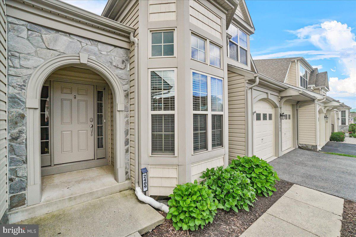 This stunning and exquisite villa is set to be a showstopper in the coveted Mill Island of Wormans Mill community. With over 4,500 total finished square feet, this spacious home offers a luxurious and comfortable living experience. Newly finished basement, updated energy efficient HVAC, fresh paint, and new carpet upstairs. As you enter the home, you are greeted by high ceilings and an open floor plan that seamlessly connects the two-story living room with cozy gas fireplace, open gourmet kitchen with large center island and ample cupboard and counter space, breakfast bar with bar stools (that convey), a formal dining room, expansive executive office, laundry room, and guest half bath. The main level also features a primary bedroom complete with two walk-in closets and a spa-like bathroom with a soaking tub, separate shower, and double vanity sink. Four professional installed skylights that open and close automatically when it rains with a bug screen gives off lots of natural lighting. Enjoy your morning cup of coffee or simply relax in the sunroom or the screened in porch which overlooks the peaceful backyard backing up to a serene, wooded area. The stone patio off the screened-in porch adds to all the great places in this home for entertaining guests. Upstairs, you'll find two additional large bedrooms, each with a walk-in closet, a full bathroom, along with a loft that can be used for a family room, 2nd office, or playroom. The newly finished oversized basement with tons of natural light, is perfect for hosting guests, creating a home theater, or turning into a home gym, with a ½ bathroom, stone fireplace, LVP flooring, and a pool table and a walk mount TV that conveys. The basement offers tons of storage space and a walk out to the backyard. The home features amazing windows that allow for tons of natural light, creating a bright and welcoming atmosphere. The community amenities are second to none, including a pool, clubhouse, walking/jogging trails, tennis courts, playgrounds, picnic areas, and more. This villa is an ideal place to call home, offering luxury, comfort, and convenience in a peaceful setting. Don't miss the opportunity to make this stunning home yours.