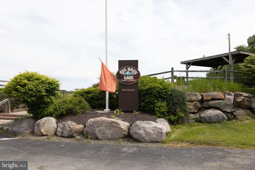 Large wooded corner lot in Big Bass Lake with a mixture of mature trees. Community amenities include: 24-hour gated security, three lakes for boating and fishing, two beaches, tennis and pickleball courts, indoor and outdoor pools, and a community center with monthly activities.Big Bass Lake is a private gated community buyers must be accompanied by their agent. Property received a septic permit for 3 bedroom home in 2014. Buyer responsible for verifying if permit is still valid as well as dimensions, SqFt, taxes and HOA fees.