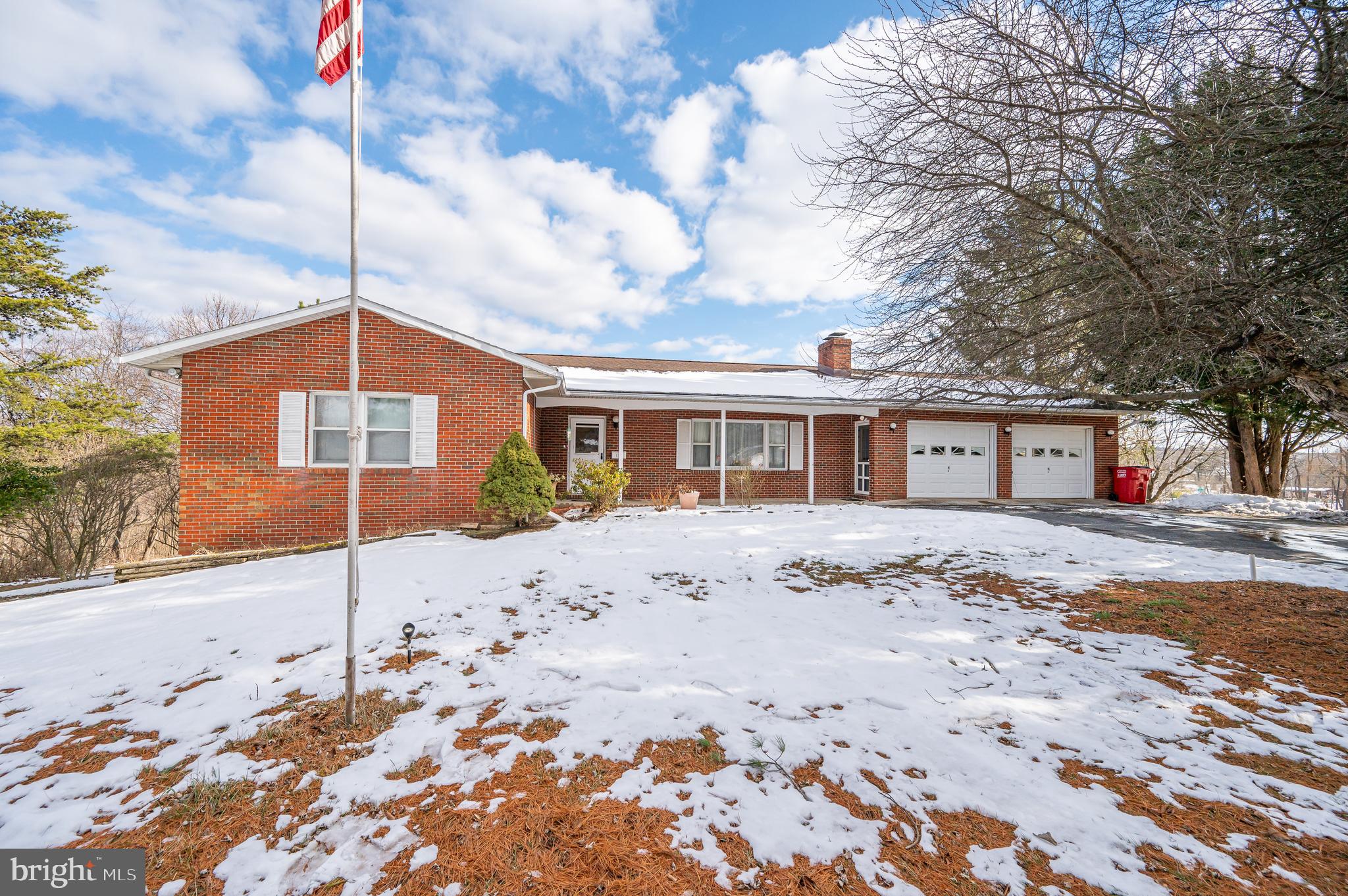 This all brick rancher sits on over a 2.52 (final survey will determine the exact acreage) and includes a 2 car, attached garage. On the main level you have a welcoming foyer and large carpeted living room. The dining room features carpet and sliding glass doors to the deck. The kitchen features easy-care vinyl floors, raised panel cabinetry and a large pantry for ample storage. There are three generously sized bedrooms with carpet and a full bathroom. The lower level of the home would be a great in-law suite. There is full bath with laundry, washer and dryer convey. There is a 2nd kitchen on this level, with a Frigidaire range. It opens onto a concrete patio. The 4th bedroom is on the lower level. There is a storage room for extra space. This home has tons of possibilities. Schedule your showing today!