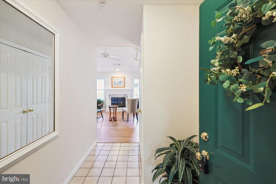 Welcome to a stunning top-floor garden condo in the heart of Reston Town Center, nestled within the unique Oak Park community. This charming condo offers a serene green space amidst the vibrant high-rise surroundings. As you enter, the foyer greets you with a spacious coat closet, setting the tone for the ample storage throughout the unit. The living room boasts a cathedral ceiling, track lighting, ceiling fan, and a cozy gas fireplace with a wood mantel, creating an inviting atmosphere for relaxation and entertainment.

Adjacent to the living room, the separate dining area provides direct access to a long, private balcony, perfect for enjoying the outdoors. The large, open kitchen is equipped with generous wood cabinetry, abundant counter space, and modern appliances including a black microwave, refrigerator, and dishwasher. Gas cooking enhances the culinary experience, while a convenient laundry closet with a stackable washer and dryer adds practicality.

The primary bedroom suite is a true retreat, featuring a spacious bedroom with a ceiling fan, a walk-in closet, and an updated bathroom. An additional corner bedroom, updated hall bath, and linen closet complete this delightful condo. A rare find, this unit includes a large storage closet on the third floor, offering even more space for your belongings.

The entire unit was just professionally painted, with new luxury vinyl plank flooring in the living areas and new plush wall-to-wall carpeting in the bedrooms, ensuring a fresh and modern feel.

Oak Park community enhances your lifestyle with amenities such as an outdoor swimming pool, picnic areas, exercise equipment, and a community center. The active condo association hosts year-round events, fostering a strong sense of community among residents.

Living at Reston Town Center means unparalleled access to a plethora of amenities, shops, and restaurants. The Reston Town Center Metro Station is conveniently located less than a mile away, providing easy commuting options. Additionally, Dulles International Airport is just 7 miles away, making travel a breeze.

Experience the perfect blend of tranquility and urban convenience in this exceptional garden condo. Don't miss the opportunity to make this your new home.