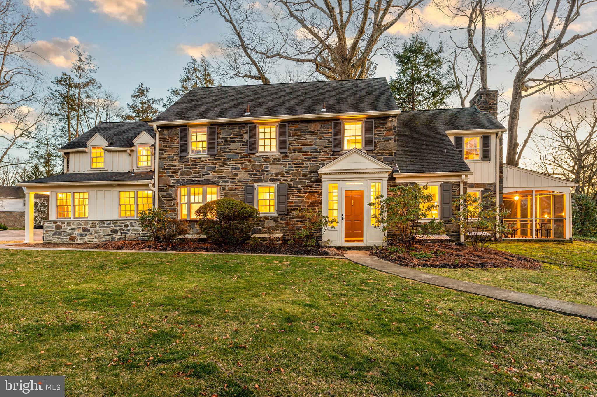 Gracious, turn-key 1930s stone colonial in walkable North Wynnewood location. This home radiates elegant Old World charm while boasting the floor plan and finishes appealing to the most discerning Buyer. Enter through the classic vestibule and enjoy the elegant archways, original random width hardwood floors, crown molding, deep window sills, recessed radiators and more charming detail at every turn. The center hall opens to a large living room with fireplace and overlooks the flat, fully fenced back yard. The living room leads to a charming screened-in side porch. A study, also off the center hall, is finished with built-in shelves and cabinetry. The dining room is large enough to host the whole family and overlooks the backyard with oversized windows. A renovated, eat-in kitchen with island and stainless steel appliances opens to a cozy family room, making this the gathering hub for the whole family. A mudroom off the driveway allows you to tuck everything in order before entering the family-room. A laundry room with exposed stone wall and a powder room with slate floors finish off the first floor. Upstairs a large primary suite is tucked apart for privacy. The primary bedroom features a large carrara marble bathroom with double vanity sink, tile shower and deep Kohler jetted soaking tub. A large lounge area includes ample closets and vanity. The primary bedroom suite is finished with a fireplace. Beautiful hardwood floors continue throughout the second floor. Two of the additional bedrooms share a hall bath with frameless glass door and basket weave tile. A fourth bedroom has an ensuite full bathroom and connects via back staircase to the kitchen. Deep closets in each of the rooms provide ample space for storage and organization. The finished basement has a second half bathroom and offers plenty of additional recreational space. Perched up on the lot, the home’s beautiful street presence is complemented by landscaping, flagstone patio, walkway and steps. The detached two car garage was completed by Gardner Fox and includes extra space (enough for even a small gym) as well as its own heat and A/C unit. The flat backyard is fully fenced. Award-winning Lower Merion School District with a short walk to Lower Merion High School. Extremely centrally located, less than a mile to Whole Foods, Wynnewood Train Station, Suburban Square and Ardmore Train Station. Commuters dream with easy access to roadways and train stations.