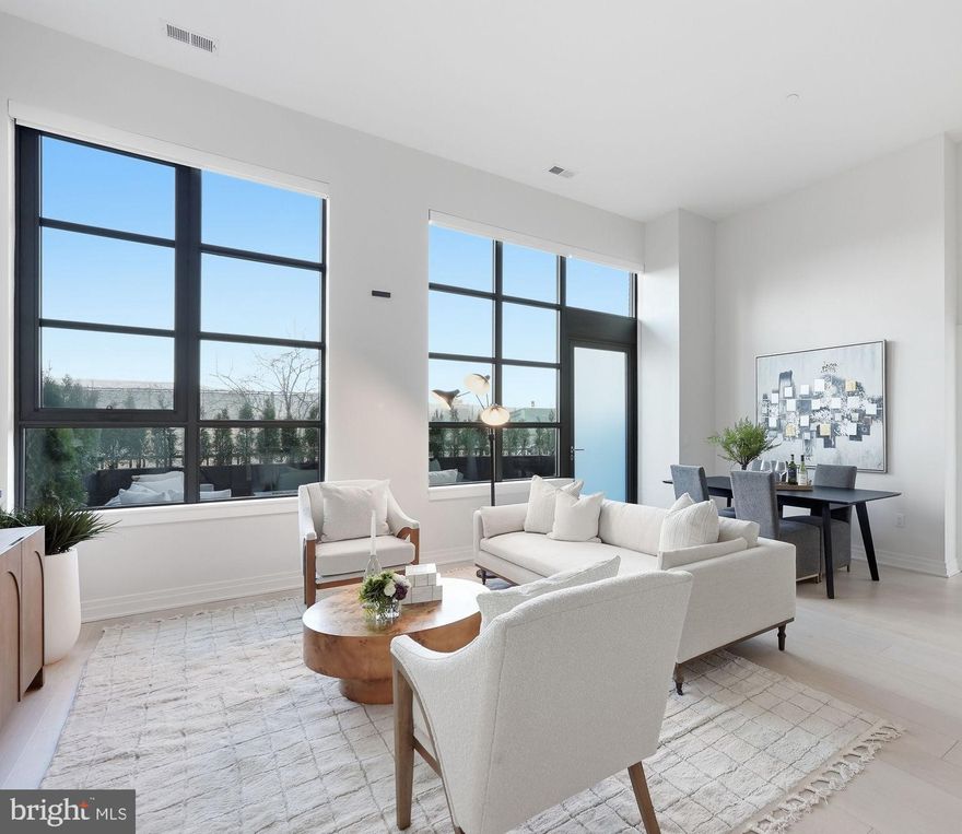 An Extraordinary Indoor–Outdoor Residence at MUSE

Unit 105 offers something truly rare in luxury condominium living: seamless, private access to the outdoors directly from your own 200-square-foot terrace. Step outside to the Mount Vernon Trail and waterfront just beyond — morning rides, sunset strolls, and fresh air are quite literally at your doorstep.

Inside, soaring 13-foot ceilings and dramatic walls of floor-to-ceiling glass flood the home with natural light, creating an airy, gallery-like ambiance. The open-concept design is both refined and intentional, maximizing every inch with clean architectural lines, 7.5-inch-wide hardwood flooring, and recessed lighting.

The chef’s kitchen is a study in modern European elegance, featuring panelized Thermador appliances, quartz countertops, an expansive island, integrated wine refrigeration, and sleek custom Snaidero Italian cabinetry. Designed for both entertaining and everyday living, it offers abundant storage including a generous pantry and extensive cabinetry.

The baths evoke a private spa retreat, appointed with Waterworks fixtures, Calacatta porcelain tile, and custom Snaidero vanities in a serene, neutral palette. A spacious laundry room, linen closet, and thoughtfully integrated storage ensure effortless living without compromise.

Adding to the rarity and convenience of this offering are two secured garage parking spaces and a private storage unit— a highly coveted combination that elevates both practicality and long-term value.

Life at MUSE is equally exceptional. Residents enjoy white-glove service with a 24-hour concierge, daytime porter, and on-site management and engineering. The rooftop clubroom captures sweeping views of the DC monuments, the Potomac River, and Old Town skyline, flowing seamlessly to expansive terraces with fireplaces, grilling stations, and refined lounge spaces. A penthouse-level fitness and yoga studio — complete with outdoor training terrace — delivers state-of-the-art wellness at home.

Perfectly positioned in North Old Town’s emerging Arts District in Alexandria, with immediate access to the Mount Vernon Trail and just moments from DC, this residence offers a lifestyle defined by connection — to light, to air, to water, and to the city beyond.

This is condominium living reimagined.