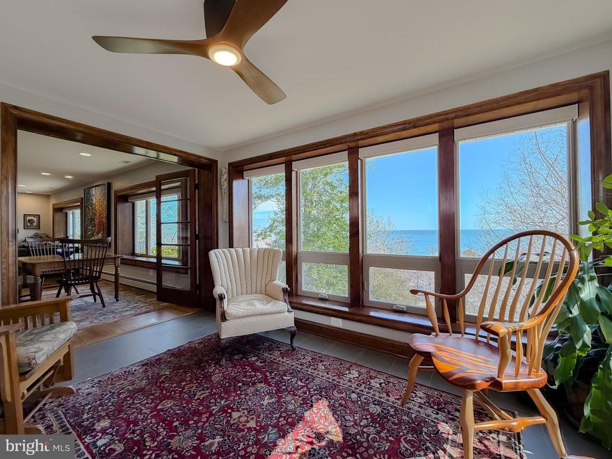 Experience breathtaking, panoramic views of the Chesapeake Bay in this beautifully updated coastal retreat. Wake each morning to stunning sunrises, spend your days strolling the shoreline in search of shark's teeth, and unwind in the evenings as cruise ships drift by on the horizon.
The main level and exterior have been thoughtfully renovated within the past six years, featuring new windows, updated plumbing and electrical systems, Hardie board siding, and a new architectural shingle roof. A welcoming foyer opens to a gourmet Kitchen designed for both function and style, complete with a spacious center island, wet bar, abundant cabinetry, and generous workspace—all perfectly positioned to capture sweeping water views.
The expansive bayfront Great Room seamlessly blends Living and Dining areas, highlighted by oversized windows and a marble-surround gas fireplace for cozy evenings. Hardwood floors run throughout, adding warmth and elegance. 
A stunning sunroom with two walls of glass fills the space with natural light and features built-in bookcases and French doors—an ideal setting for relaxation or showcasing your indoor garden. You and your plants will flourish in this space!
The main level offers two generously sized bedrooms with cedar-lined closets, along with a beautifully appointed full bath featuring a whirlpool tub, custom walk-in shower, and thoughtfully designed storage. A third bedroom—currently used as an office—boasts spectacular views and its own private entrance via a charming garden walkway. A spacious half bath completes the main level.
 Highlights include solid wood doors, ceiling fans, and Hunter Douglas blinds throughout the bayfront windows, creating a refined yet comfortable living environment—all on one level.  Annual service contracts on furnace and HVAC. 

The lower level adds flexibility with a finished office space featuring water views and a full bath with shower.. The remaining area offers endless potential to customize, with the existing plumbing, from a former wet bar, still in place. A brand-new sliding door opens to the backyard, providing another peaceful spot to take in the bay views.

Outdoors, the property continues to impress with beautifully landscaped grounds, gardens, and a unique private labyrinth—circuitous path  for walking, meditation and relaxation. A storage shed is also included.

Enjoy a short stroll to the beach for swimming, crabbing, or fossil hunting. Boating enthusiasts will appreciate nearby Flag Harbor Marina within the Long Beach community, offering deep-water slips for purchase and quick access to the Bay. Flag Ponds Nature Park, known for its scenic cliffs, beach access, and fossil hunting, is also within walking distance.  Road fees of $75/yr  Civic Association fee of $125/yr giving you  Beach access.

Whether you're seeking a full-time residence or the perfect weekend escape, this move-in-ready home offers the ideal blend of comfort, style, and coastal living. Summer is calling—don’t miss this exceptional opportunity.   Better yet, NO Bay Bridge to cross!!!