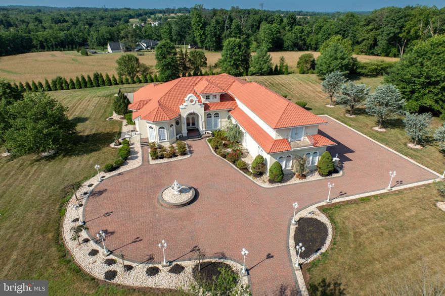 Experience the allure of this custom-crafted residence, eagerly awaiting your ownership. 1956 Hunt Valley Rd is an exceptional  6-bedroom, 5.5-bathroom home situated on a sprawling 1.86-acre lot within a peaceful cul-de-sac.  It offers both panoramic views and seclusion, a rare combination. 

Indulge in luxury within this haven, complete with a 4-car garage featuring heated floors, complemented by additional driveway parking. Pella windows grace every corner, adorned with pleated blinds for both elegance and privacy. The interior showcases 10-13ft ceilings, adorned with bespoke flooring and walls that exude character. A striking study/office beckons, adorned with a custom desk, built-in bookshelves, a half bath, and double crown molding.

Step into the dining room and be captivated by the shimmering Swarovski chandelier. The kitchen boasts an open concept that seamlessly connects to the living room. Adorned with crisp 42-inch white cabinets, topped by 18-inch glass display cabinets, it offers ample storage including a pantry, an island with additional storage, granite countertops for food preparation, and heated ceramic floors. The kitchen offers easy access to the 4 car garage and laundry room.

The living room is a vision of comfort, featuring a double-sided fireplace and triple bay radius windows that overlook the inviting pool and lush yard. The 1st floor primary bedroom is a retreat complete with  his and her walk-in closet and double-sided fireplace, perfect for unwinding. The en-suite bathroom features a jacuzzi tub, double vanities, and arched transom top bay windows. Three additional generously-sized bedrooms are thoughtfully located on the opposite wing of the home, with large closets and a stylishly designed jack-and-jill bathroom featuring a jacuzzi tub. 

The current owner has invested about $70,000  in new appliance upgrades, new 9 inch width waterproof laminate flooring in 4 rooms on the main level and  above garage in the law suite or au pair living quarters  ( additional material left to do the dining room).  Upgrades include GE appliances 2023, Kitchen backsplash 2023, LG Washer/Dryer 2021, ADT Security 2021,  Fence and Garden in ground irrigation 2022, Movie room projector, drop down screen, audio wiring 2022,  Exterior timers for security lights and front entrance light, re grouting pool bathroom Sept. 2023 and chlorine injection pump for the pool 2023.

An elevator graces the home, transporting you to the basement where entertainment awaits. Discover a custom-built bar, a theater room bedecked with dimmer lights, elevated recliners, a 3D TV, and surround sound – an entertainer's dream. A recreational area, full bathroom, and two flexible rooms that could serve as bedrooms, offices, or exercise spaces complete the basement.

Outside, the changing seasons offer a stunning backdrop for the in-ground 20x40 ft heated pool, accompanied by an 8-person jacuzzi and an outdoor kitchen/grilling area. But there's more - this remarkable home also includes an in-law or au pair suite featuring 2 bedrooms, 1 bathroom, a full kitchen, with new waterproof laminate flooring and a washer/dryer closet and connection.

Immerse yourself in the splendor of this truly unparalleled residence, a testament to extraordinary living both inside and out.