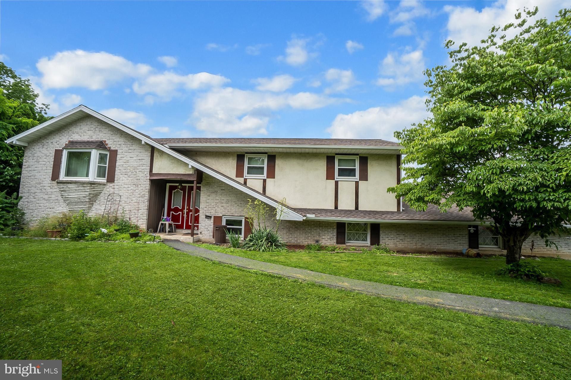 Discover the potential in this spacious 4-bedroom, 2.5-bath bi-level home in Parkland School District, perfect for buyers looking to add their personal touch. Situated on a generous lot, this property features a rare 4-car garage and plenty of off-street parking, offering ample space for vehicles, hobbies, or storage. The upper level includes a traditional layout with a bright living room, dining area, and a functional kitchen with access to the covered patio—perfect for entertaining and overlooking the inground swimming pool. This level also includes a full bathroom, two well-sized bedrooms, and a spacious primary suite complete with its own en suite full bathroom. The lower level offers flexibility with a second kitchenette, a large family room with a fireplace with access to the sunroom, the 4th bedroom, a half bath, and walk-out access to the backyard and pool area—ideal for in-laws, guests, or extended living. The roof was replaced in 2019 and the water heater was replaced in 2022. While the home needs some TLC, it presents a fantastic opportunity to build equity and customize it to your tastes. With solid bones, multiple living areas, and a prime layout for entertaining, this home is full of potential. Selling in "as-is" condition. Don't miss your chance to transform this well-located property into something truly special!