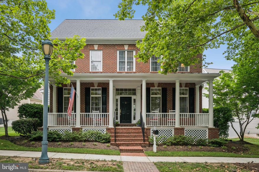 Welcome to a home built for beautiful moments and lasting memories.

Nestled in the heart of King Farm’s coveted Watkins Pond neighborhood, this stately brick-front residence—with its wide, welcoming front porch, perfect for sipping lemonade with neighbors or enjoying a quiet morning coffee—offers timeless charm and modern ease. With thoughtful updates throughout and a layout designed for both connection and comfort, this home is better than brand new, combining high-end finishes with warmth, character, and exceptional flow.

Step through the front door into a grand foyer with a sweeping staircase and soaring 10'+ ceilings that create an open, airy ambiance. Brand-new hardwood floors span the main level, where every room invites you to relax or entertain with ease. The formal living and dining rooms offer elegant spaces for special occasions, while the bright family room—complete with a wall of windows and a gas fireplace—is ideal for everyday living.

The updated kitchen is the heart of the home, featuring quartz countertops, stainless steel appliances, and ample prep space—perfect for hosting gatherings that flow seamlessly into the family room and out to the patio. Just off the kitchen, a spacious rear bonus room provides endless possibilities: breakfast room, music room, reading nook, mudroom, or creative flex space.

The private office, located just off the foyer, includes French doors for quiet focus, and a stylish powder room is conveniently located nearby for guests.

Upstairs, the serene primary suite offers a tray ceiling, cozy sitting area, two oversized walk-in closets, and a spa-inspired bath with soaking tub, frameless glass shower, and updated lighting and mirrors. Two additional bedrooms each feature walk-in closets, newer carpet, and private en suite baths. A fourth bedroom suite, located above the garage, adds even more flexibility for guests, work-from-home needs, or hobbies.

The finished lower level is made for fun and functionality, with a large recreation area, built-in bar with wine fridge, gym, bonus room, full bath, and ample storage.

Step outside to one of King Farm’s largest backyards, complete with a beautifully designed brick patio—ideal for alfresco dining, gathering with friends, or relaxing under the stars. The two-car garage and extra-long driveway are a rare find in the community, offering generous parking and convenience.

Major upgrades include a newer roof, two updated HVAC systems, and a modern heat pump, ensuring lasting comfort and efficiency.

But the home is only half the story—King Farm offers a lifestyle like no other. With tree-lined sidewalks, walkable access to parks, playgrounds, and green spaces, and two sparkling community pools, every day feels like a getaway. Enjoy tennis courts, a village center with shops, restaurants, and a Safeway, and a dedicated shuttle to the Shady Grove Metro for easy commuting. Year-round neighborhood events—from outdoor concerts to farmers markets—foster connection and community at every turn.

This is more than a house. It’s a place to live fully, entertain joyfully, and make lasting memories in one of Rockville’s most cherished neighborhoods.