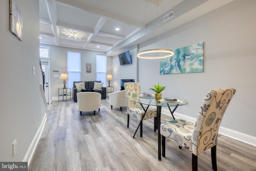 Amazing opportunity to own three levels of modern beauty in this affordable home located in the sought after community of East Baltimore. This beautiful move-in ready home has been updated with 5-bedrooms, 3.5-bathrooms, and offers a host of upgrades and features. This residence seamlessly blends contemporary living with classic charm across three thoughtfully designed levels. Come enjoy all the serenity and comfort this home has to offer. 

Upon entry to the main level, prepare to be amazed by the charm and open concept that promotes an abundance of natural light and neutral colors that will match your chosen decor. As you walk through this large home that features luxury vinyl plank flooring throughout the first level, notice the spacious living room with custom coffered ceilings and fireplace with several heat and light levels that promote the obiance for relaxation. Connected is your dining area with a beautifully designed custom ceiling and gorgeous lighting. Adjoining, is the kitchen with new soft close custom cabinetry with gold arm handles, large pantry cabinet, designer kitchen lighting, quartz countertops, and peninsula with quartz waterfall countertop, pendant lighting and extra seating. The upgraded stainless steel appliance package includes a five burner range, side-by-side refrigerator, dish washer, and built-in microwave. 

Enjoy your first floor powder room that features a stylish floating vanity with LED mirror and gold faucet finishes with black toilet. Just beyond the powder room is the first floor laundry located just before you step into the spacious first floor bedroom or office. Step outside onto your rear porch area with space for seating and eating.  Just travel down a few steps to enjoy the rear patio with privacy fence and plenty of space for outdoor entertainment and barbecues with family and friends.

Journey upstairs on hardwood steps with a view of designer lighting.  The second level has three large bedrooms with ample space and storage. The owner’s suite facing the front of the house features recess lighting, designer “smart” ceiling fan, large closet, fireplace and sitting area. Walk into the owner’s suite's spacious bathroom which features a shower with designer ceramic floor to ceiling tile, large niche and skylight. There is a large double vanity and LED mirror with built-in lighting and anti-fog features. Step into the hallway and then into the second bedroom with ceiling fan and remote. Further down the hallway, relax in your spa-like bathroom with a bathtub/shower combination, designer tile with niche, modern vanity, and designer mirror and light. There is also an additional huge third rear bedroom with another ceiling fan with remote.

The finished basement introduces a fifth bedroom, a stylish full bathroom, and flexible space for an office or recreation room and additional storage space under the steps. Enjoy three levels of contemporary living with classic charm in your new residence. 

Ask how you may qualify for multiple grant programs and down payment or closing help including, but not limited to $10,000 vacant to value (V2V), $5,000 Buying into Baltimore , $20,000 Baltimore City Grant (Community developer block grant) and more!

This home is conveniently located close to Johns Hopkins Hospital, Johns Hopkins University, University of Maryland, Wilmer Eye Institute, Kennedy Krieger Institute, downtown Baltimore City, Inner Harbor & fine restaurants. 

This is luxury living at affordable pricing! Come enjoy all the serenity and comfort this home has to offer. Schedule your showing today!