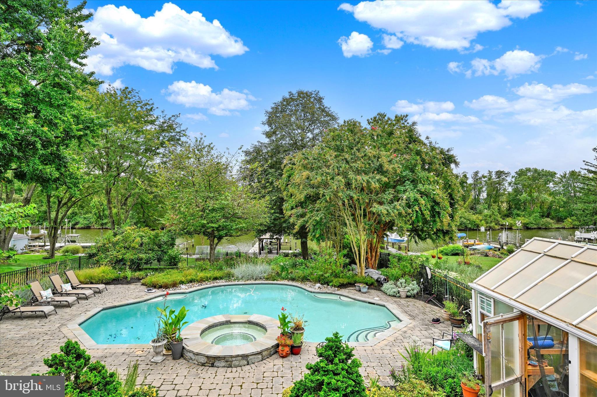 Welcome to 20 Neptune! This waterfront haven offers 3 bedrooms, 2.5 baths, and the rare blend of everyday comfort, energy efficiency, and unforgettable living. Privately tucked along the Gunpowder River with easy access to the Bay, it’s more than a home, it’s a lifestyle. From your private dock, complete with boat lift, kayak launch, and gazebo, you’ll watch eagles soar and herons glide at sunrise, spend the day on the water, and still be back in time for a sunset cruise, with fishing or crabbing just minutes away. (Flood insurance NOT required.) Protected land across the horizon ensures your view, and your peace, will never change. With sidewalks throughout the community and Mariner Point Park just 2 miles away, daily dog walks and bike rides couldn’t be more enjoyable. Your outdoor spaces here don’t just impress, they announce that you’ve arrived at the lifestyle you deserve. The salt-water pool with spa is framed by gardens designed by a Maryland Master Gardener, providing a four-season landscape of color and privacy. Multiple balconies, a greenhouse with rain collection, extensive hardscaping, and a fully fenced yard (pet-ready) create spaces to gather, garden, and unwind. Pool, spa and grounds lighting, controlled by an app, extend the lifestyle well into the evening. When it’s time to cook for a crowd, you’ll love the effortless flow from the outdoors to the kitchen, complete with a chef’s gas stove with external venting and generous counter space that frames views of the outdoors. The family room also opens seamlessly to the pool terrace for effortless entertaining. Heated tile floors in the family room, owner’s suite bath, and second bedroom "sunroom" create daily luxury, while the owner’s suite itself offers a massive walk-in closet, private balcony, and spa-like bath. No major expenses ahead, this home is fully prepped for long-term comfort: brand-new roof with GAF Timberline® Lifetime Shingles is scheduled for installation this October, complete with the prestigious GAF Golden Pledge® Warranty (lifetime material coverage for 50 years, 25 year coverage on installation errors), offering unmatched peace of mind with industry-leading coverage, workmanship protection, and long-term durability for decades to come. Trane High-Efficiency HVAC (2021), Paid-in-Full Solar PV System (2011) for maximum energy savings. Crawlspace and attic encapsulation/insulation for energy savings and healthier air. Pool automation and upgrades including Raypak heater, high-efficiency pump, iAquaLink smart controls, and new custom cover (2023). Smart Features & Appliances: Bosch dishwasher (2021), refrigerator (2020), garbage disposal (2020), smart thermostat, ethernet wiring, and so much more. This is what the seller says about this home: “What I love most about this home is the view and the peace it brings. It’s the kind of view you rarely find and one that will never change. The pool feels like a private oasis, the gardens bloom with life, and every day begins and ends with nature right outside my window. It’s a sanctuary.” Can you see yourself here? Say YES and book your appointment now. This home won't last long!