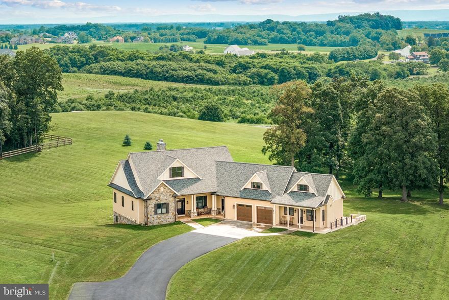 Turn-key and meticulously maintained, this 2021 custom craftsman home by well-reputed local builder Foreman Builders is thoughtfully designed and ideally sited on 3.85 acres, with views from every room.
The light-filled interior (4,850 finished sq ft)  features a flowing main-level layout, perfect for both entertaining and everyday main-level living. The vaulted Great Room centers around a wood-burning stone fireplace and opens to the rear deck through French doors. Host and chef alike will appreciate the kitchen with its large island, custom cabinetry, granite countertops, WiFi-enabled appliances, and wine fridge.    The spacious primary suite offers two walk-in closets, a spa-like bath with radiant heated floors, rain shower, jetted soaking tub, and private deck access—perfect for morning coffee. Two ensuite bedrooms on the lower level share a second living room with a fireplace and open to the rear patio--an ideal private setting for a future pool. From there,  access the gym that will inspire even the most reluctant.   With flexible spaces throughout—including a dedicated office off the foyer, a bright finished bonus room over the garage, and additional lower-level space ready to be finished—this home easily accommodates remote work, schooling, or hobbies.    A separate, stylish 1-bed/1-bath apartment provides excellent space for in-laws, an au pair, or rental income.   See the Features List in the documents section for more details. Most of the furnishings are available for separate purchase.  No HOA.