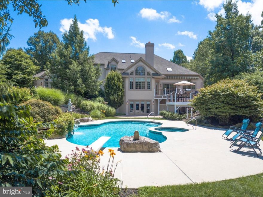 SALE PENDING;  In a day when so many houses seem to repeat the same designs and styles, this amazing house stands apart. Lovely architectural design is the hallmark of this stunning residence, where every surface has been recently redone and where the legacy location is perfectly-positioned on 2.5 breathtaking acres. A newly-updated exterior takes advantage of established and mature, professional landscaping. All of these fabulous new appointments are the very definition of today's trending homes. Inside, incredibly-appointed rooms have been repurposed with panache, and are sun-filled and generous. The two-story foyer, with curved stairway, is flanked by an elegant dining room and gracious living room, giving entry to the family room with stone FP and cathedral-ceilinged breakfast room beyond. Custom moldings, built-ins and hardwood flooring define each first floor space. A first floor office has built-in bookcases. Adjacent, the first floor master bedroom offers its own master deck with steps to the pool and spa, two walk-in closets and a large master bath. Completing the first floor is a sleek 2017 custom kitchen with new appliances, center island and cathedral ceiling, all overlooking a breathtaking backyard. As would be expected of a home of this quality, the overall design works seamlessly. The second floor has 4 additional bedrooms. This sophisticated floor plan boasts over 6972 square feet of living space on three levels. The newly-finished, daylight lower level with 9 foot ceilings, a game room with custom bar and fireplace, full bath, professional home theatre room, gym and large exterior windows and doors. Finally, the backyard oasis is an amazing area with a heated pool and spa, waterfall, custom lighting and access from both the upper and lower levels. This will quickly become your favorite summer location and, also, a view to cherish in every season.