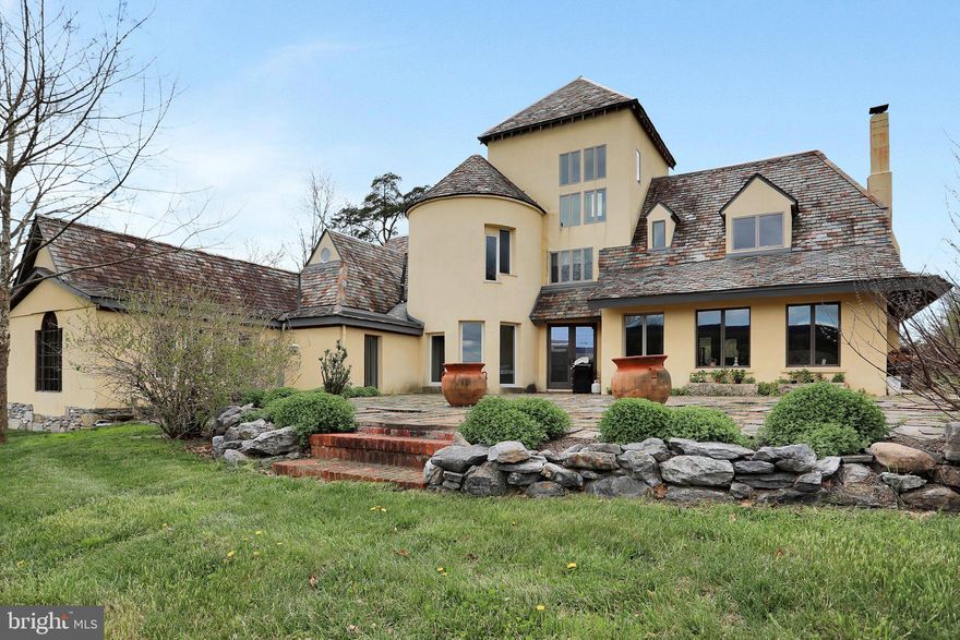 Solitude. Charm. Luxury. Welcome to "Far End" - a custom designed and built home inspired by French provincial farmhouse style. Step into another world tucked away at the end of a long drive overlooking 13+ acres of fields and old growth forest along winding Sleepy Creek. A welcoming open floorplan on the main level embraces you with exposed reclaimed wood beams, wood floors, and copious natural light through windows showcasing the setting. Enjoy the geothermal HVAC system and the heated floors throughout. The main-level primary suite features a vaulted wood ceiling and takes advantage of the mountain views. Three additional bedrooms and two luxury baths are on the second level. The third bedroom (or potential office) features a soaring domed ceiling, unlike any bedroom or office you'll ever see. The loft space on the third level could be a library reading nook, an artist retreat, or an additional bedroom. Enjoy the gardens and the incredible view of the fields and mountains from the expansive slate terrace, or the creekside sights and sounds from the trex deck. The property also has a detached 4-car garage, a large open shed, two wells, dimensional landscaping, and is suitable for horses. All this is just 90 minutes from the Beltway.