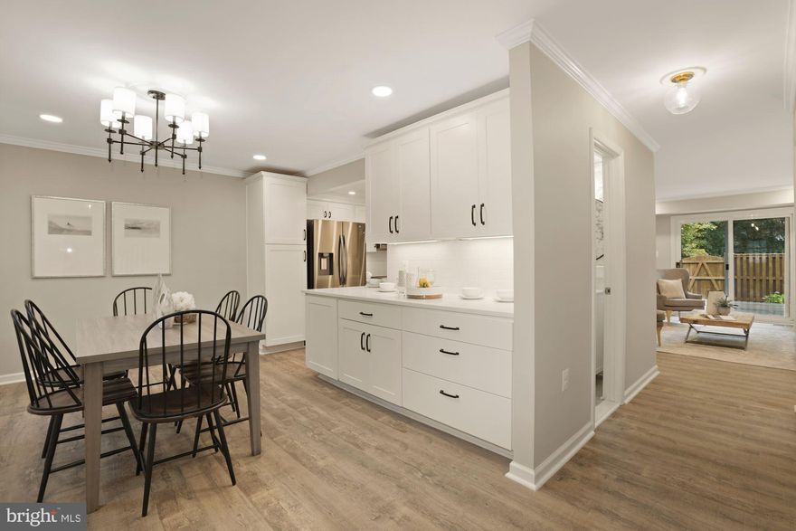 This is the home you have been waiting for. Stunning renovations by a high-end premier builder. A total of 3 bedrooms plus an office on the main level and a den in the lower level, 3 full baths and 1 half bath. Expanded kitchen with solid quartz counters, maple cabinets, deep single bowl sink, pantry cabinet recessed lights, under cabinet lights and stainless-steel appliances, open to an expansive dining room. New office on the main level. A jewel of a powder room with Pierre-Deux like wallpaper, wainscotting and hex floor tiles. Sunny living room with access to a large new composite deck in a fully fenced yard. Privacy abounds as this end-unit townhome backs parkland. New scratch resistant, waterproof LVP flooring through the main level, the stairs and in the basement. Spacious primary bedroom with two closets and an expanded, renovated bathroom with dual sink on a premium quartz counter, custom glass shower door, separate rain head and handheld showers on a 3-function valve. Two secondary bedrooms sharing a renovated hall bath. All closets outfitted with custom shelving. New finished basement with den, full bath, rec room and storage. Crown moldings throughout the main level, upper-level hallway, primary suite and the basement. Upgraded 6-panel doors and colonial trims. New roof, gutters and downspouts. New HVAC. Newer windows. New insulation in the basement and in the kitchen and dining room. Beautiful home in a great neighborhood. OWNER IS AGENT. Park on any of the 3 spaces marked 5847. Open on Sunday 11/7 from 2:30PM to 4PM. Offer Deadline Tuesday November 9 at 12 NOON.