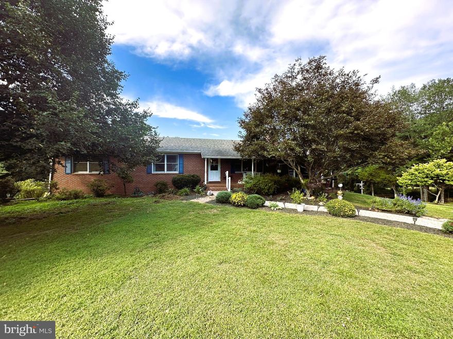 All brick 4 Bedroom, 3 Full Bath Rambler, situated on 3+ acres in the desirable Malvern of Madison community.  A landscape lover’s dream, with so many mature trees, and beautiful shrubs and plantings.  Japanese Maples, Magnolia, Crepe Myrtle…….the list goes on.  Tons of yard space surround the home, perfect for outdoor activities or peaceful evenings.  Relax on the expansive rear deck (with gas grill hook-up) or covered front porch, both overlooking the pleasantries of nature.  Perfect choices for your morning coffee or evening gatherings.  Inside, this brick home features a spacious layout with nearly 2,000 sq. ft. of finished living space on the main level, and additional finished space downstairs.  A welcoming Family Room greets you as you enter, complete with a double-sided fireplace, offering a cozy touch.  Flow directly into the Kitchen to find all of the essential stainless steel appliances, granite countertops, and an island for that on-the-go breakfast or informal gathering.  Hardwood flooring flows seamlessly throughout the main level.  Don’t miss the light filled expansive Dining Room just off the kitchen, also accented by the dual-sided fireplace.  There are three roomy Bedrooms on the main floor and two Full Baths.  You’ll appreciate the walk-out lower level and all it has to offer.  The convenience of a second Kitchen, another Full Bath, a fourth Bedroom, as well as, Den/Office space and unfinished storage.  Additional highlights include a large garden shed, paved circular drive with additional parking space, wi-fi capable/Bluetooth smart thermostat, and highspeed internet!  The Malvern community offers a swimming pool, clubhouse, playground and Lake Malvern access.  Welcome to a perfect balance of backyard tranquility and community living!