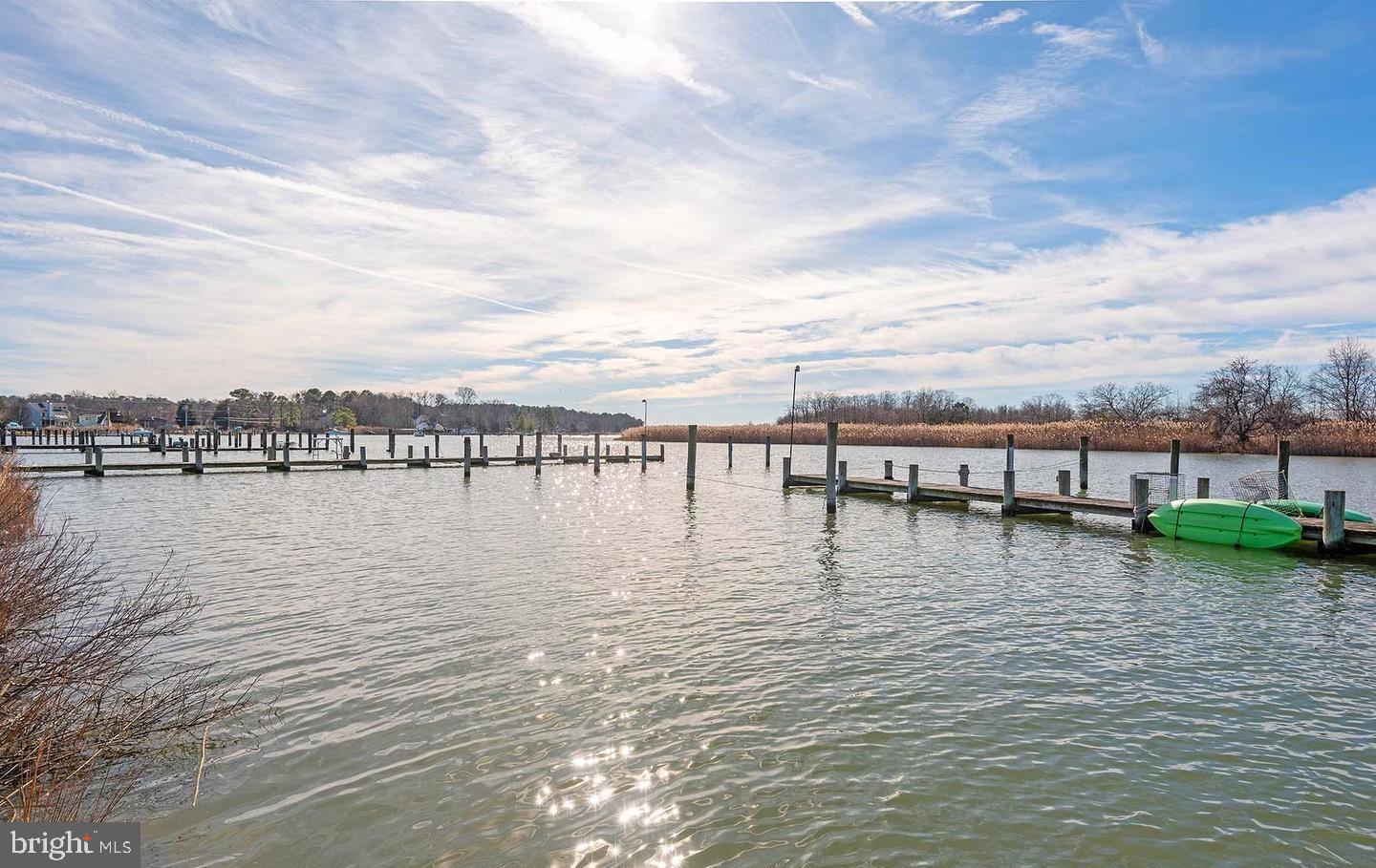 Enjoy this quiet neighborhood and be close to the water! Walk into a light and bright unit with vaulted ceilings with wood beams, enjoy the cozy wood stove in the colder months. Upper level includes the primary bedroom with en-suite. Two additional bedrooms and a hall bath completes the level. A loft is the perfect space for additional living space or home office. There is parking for one car in a garage with room to park a second car outside. Additional parking is very convenient. The community offers a pool and a clubhouse with a picnic area. Condo fees include trash, water and sewer. Close proximity to Bay Bridge. Walking distance to shopping, restaurants, and banks. Boat slips are available through the association and do not convey.