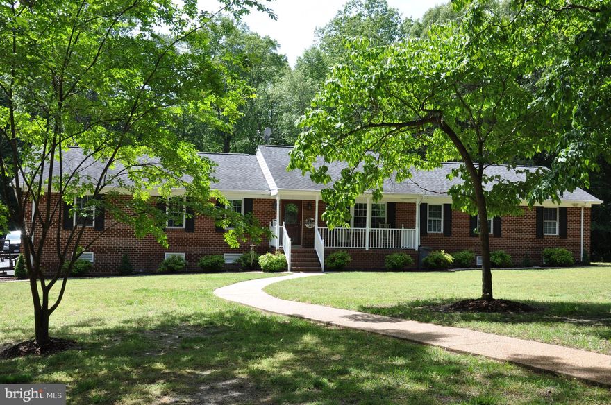 **Beautiful brick ranch on 4.8 acres in Mechanicsville, walking distance to Pole Green Park/ Dog Park and only minutes to 295, shopping, restaurants and more. **This split design ranch features a primary bedroom with 2 walk-in closets (one with custom shelving & a clerestory window), a sitting area and an updated bath with a 5’ walk-in shower. On the opposite end of the home there are 2 additional bedrooms with new carpeting. In addition to the hall bath that showcases custom built cherry cabinets, there is another full Jack-n-Jill bath that also features custom built cherry cabinets between bedroom #3 and the Office that features a closet with new carpet.  This home also features a Formal Living Room, large Eat-in-Kitchen with custom built cabinets (2018), sunken Family Room, Laundry Room, a 12 x 10 Bonus Room and a Walk-up Attic. **The Formal Living Room has a marble hearth. The Family Room and Laundry Room have been updated w/ Mohawk engineered hardwood flooring. The main entrance of this home showcases an Anderson-stained glass front door & storm door with dual screens. Family Room has Anderson sliding doors w/ security lock features and the Laundry Room has an Anderson door that features a built-in window. 
**Additional features: gutter guards, generator hook-up & a 5-ton heat pump (2023), 2 sheds (12X24) on the property, one w/ electricity. Property has a shooting range that was reviewed by the county & accepted and there’s still plenty of land to do whatever you desire, as there is NO HOA. (Room for a pool or large workshop/garage, etc.) **This home is an entertainer’s delight with the expansive paved driveway & the newly updated low-maintenance Fiberon/Vinyl deck (2023) & stamped concrete patios will make your parties stand out. Or you can just enjoy the peace & quiet that comes with this secluded home. *Note: there is no road signage for this property, as we prefer to keep the area private and tranquil.*