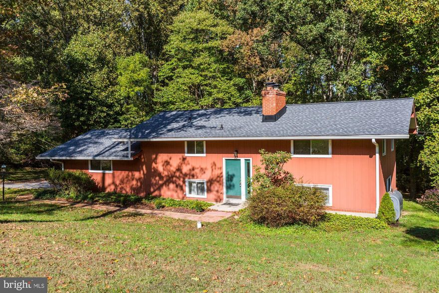 This picturesque, private, cozy and captivating split-level contemporary home offers open and comfortable gathering places that make you feel like this is a true tradition home.  Sunlight pours in through large windows in all four bedrooms on the upper level. Vaulted ceilings accented with exposed beams add to the charm. The primary bedroom boasts new carpet and private full bath. The main level features a huge family room with wood-burning fireplace and brick hearth. A large sliding door to the back yard provides scenic views for all seasons. The newly-remodeled kitchen includes all new stainless steel appliances, granite countertops, table space, recessed and track lighting. The living room also offers bright windows, ceiling fan & new carpet. A mud room with garage access and laundry room with new washer & dryer/half bath complete the main level. Additional features: NEW roof 2020, NEW above ground oil tank, NEW kitchen and newly remodeled bathrooms, NEW carpet throughout, NEW CPVC interior plumbing, two car attached garage, brick sidewalk and beautiful four-acre yard with mature trees...Welcome home!