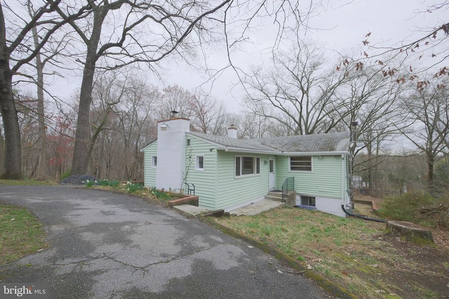 Cute raised rambler with stain glass windows on almost 4 acres of RR- Rural Residential zoned land with sub-dividing potential.  3 bedrooms, bathroom and spacious living room on the main level. Lower level includes kitchen with granite and stainless steel appliances, dining room, family room and enclosed sun room overlooking your private wooded lot. 2 sheds convey on the property. Boiler replaced in 2017. Selling As-Is. Come make this unique property your home.