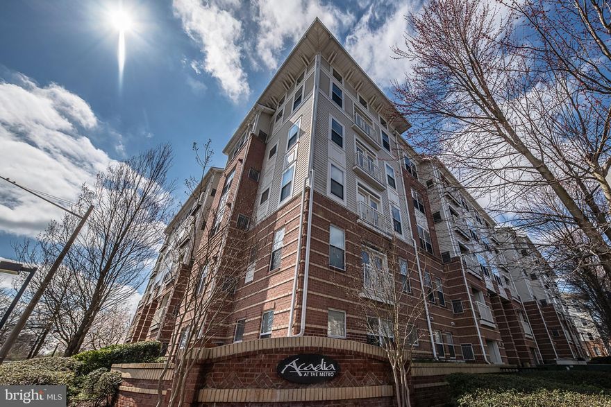 Beautiful condo in the heart of Vienna! Only ONE block away from Vienna Metro - perfect for commuters or for anyone who loves to explore the DMV area! Acadia condo community is filled with amenities. A 24 hour fitness center, outdoor pool, indoor basketball court, golf simulator, cafe, game room, media room, and office room!! This sunny, first level unit boasts a corner parking spot in the parking garage (G2-95). Enter to find the kitchen on your left, and an office with a built-in desk on your right. This room will be wonderful for working from home. Also find a washer and dryer tucked away. The open floor plan is great for entertaining. The dining and living area features stunning hardwood floors and leads out to the balcony with a storage closet. The relaxing master bedroom has a large window and a walk-in closet.  The bathroom features a vanity with a large countertop! Trash drop off is right down the hall. Water included in association fee. If you're on the hunt for your perfect home, look no further!