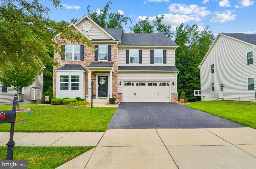 Welcome to 10378 Sugarberry Street! This meticulously maintained, modern, turn-key ready and spacious stone-front home is located in the heart of the highly sought after Autumn Hills Community. Enjoy over 4,000 sq ft of livable space in this 4 bedroom, 2 and a half bath classic colonial. This home boasts the following sweet amenities: recessed lighting, hardwood floors throughout the main level, formal living and dining room, sunroom, family room with a stone wall fireplace, owner’s suite with double sinks, soakers’ tub and a separate shower with two walk-in closets, upper level loft area, spacious bedrooms, granite countertops, stainless steel appliances, oversized island, fenced-in backyard that backs up to a wooded area for privacy, deck, patio, fully finished basement, top floor laundry room, two car garage and many more! This home also offers easy access to Washington DC, military bases, shopping, dining and more! Don’t wait. This is a must-see home!