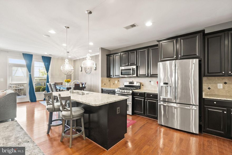 Welcome to this beautifully maintained Covington model townhome by Van Metre Homes, ideally located in the heart of Stone Ridge, VA. Built in 2013, this 2-level home offers 3 spacious bedrooms, 2.5 bathrooms, and a 2-car garage, combining thoughtful design and modern convenience.

The main level boasts an open-concept layout with gleaming hardwood floors, abundant natural light, and a cozy gas fireplace in the large family room. The gourmet kitchen is a chef’s dream, featuring a large granite island with seating, GE stainless steel appliances, a 5-burner gas cooktop, an oversized walk-in pantry, and ample space for a large dining table. Step outside to a private, fenced-in brick patio—perfect for relaxing or entertaining.

Upstairs, you'll find a versatile loft ideal for a home office, a conveniently located laundry room, and three generously sized bedrooms. The luxurious primary suite includes two walk-in closets and an en-suite bath with dual vanities and a seated shower.

Enjoy all that the award-winning Stone Ridge community has to offer: three pools, a clubhouse with fitness center, playgrounds, Byrne Ridge Park, and the Stone Ridge Sharks Swim Team. Walk to Gum Spring Library, Harris Teeter, Brew Birds, and Bruster’s Ice Cream. Close to StoneSprings Hospital. Commuters will love the proximity to Loudoun County Transit options to Metro and D.C., and Dulles International Airport is just 11 miles away.

This move-in ready townhome offers the perfect blend of style, space, and location—don’t miss it!