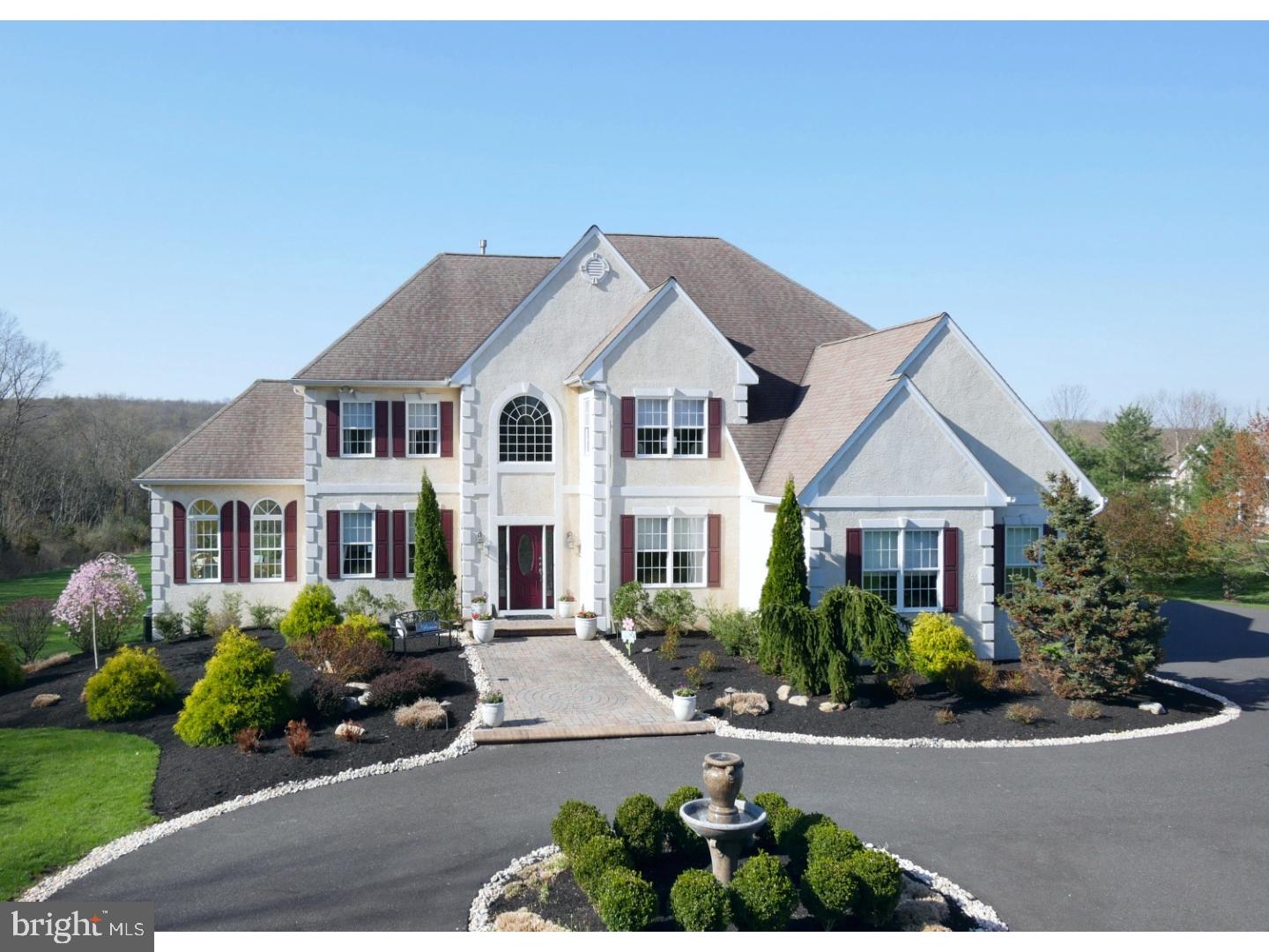 A private driveway leads into a dramatic circular entrance w/ water fountain. This custom built home sits on a 5 Acre, perfectly manicured lot. At over 4,991 SF, 4 bedrooms, 3.2 baths. Dramatic two-story foyer w/turned staircase and marble style floors. Formal Living/Dining room features a double sided fireplace leading into a Sun Room with built-in bookshelves and circle top windows. Gorgeous kitchen has an abundance of custom cabinets, large center island, 12" tiles floors and a breakfast bar area with Granite surface. Family Room has floor to ceiling stone fireplace, wall of windows capturing the beautiful views and electronic window blinds. Owner's Retreat features a tray ceiling, sitting rm area and a super walk-in closet w/ dressing island. Bedrooms have custom built-ins, desk areas and window seats. Home is completed by the partially finished walk-out lower level leading to a large paver patio and Gazeebo. Upper level flows onto a large, composite deck w/ electric awning.