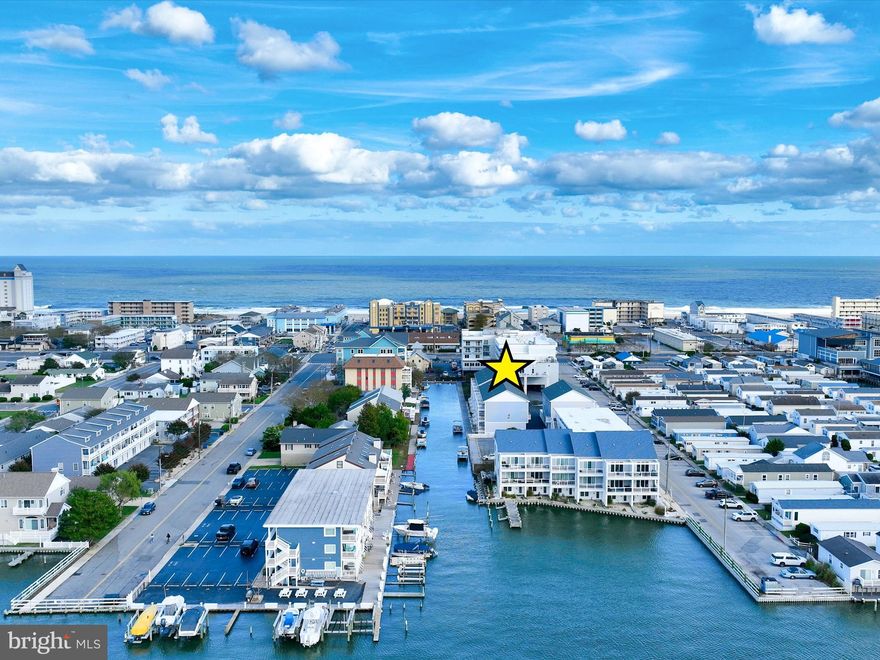 Coastal Living at Its Best in Island Cove

Imagine waking up to the gentle shimmer of the water and the scent of salty ocean air. This beautiful three-year-young condo in Island Cove captures the essence of coastal living, offering serene water views, modern finishes, the perfect blend of comfort and convenience, and is being sold fully furnished for a turnkey experience.

Situated between the ocean and the bay, this contemporary retreat features three levels of outdoor living, each with its own balcony to take in the ocean breezes and stunning views. Step outside your front door, hop on your boat, and set off for your next adventure, whether it’s boating, fishing, or simply cruising the bay.

Inside, you’ll find light-filled spaces styled in soothing coastal tones. The entry level features a private bedroom with a sliding barn door leading to an attached bath, plus direct access to the two-car garage.

The main living level is open and airy, designed for easy entertaining and relaxed everyday living. The kitchen boasts white quartz countertops, sleek tile backsplash, stainless steel appliances, and an island with seating that’s perfect for gathering with friends and family. Flowing seamlessly from the kitchen are the dining area and spacious living room, which opens to a balcony where you can unwind and enjoy the view. Durable LVP flooring runs throughout this level, adding both beauty and practicality.

Upstairs, you’ll find two spacious bedrooms, each with its own private en suite bath. The primary suite is a true retreat, featuring a vaulted ceiling, private balcony, and a spa-inspired bathroom with a dual vanity and a glass-enclosed tiled shower with a rain shower head.

Whether you’re looking for a full-time residence, vacation home, or investment property, this Island Cove condo offers a low-maintenance, high-style lifestyle just moments from the sand, surf, shopping, and dining.