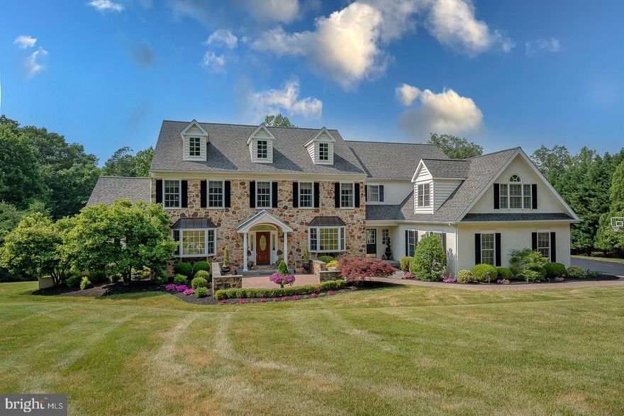 Welcome home to 3 Whisper Lane, a beautiful stone front 5 Bedroom Colonial nestled in the highly coveted Blackberry Hills subdivision of Charlestown township. A lovely front patio nods to the thoughtful, custom details to be found throughout this home. Enter into the grand Foyer with hardwood floors, elegant millwork, and crown molding. Continue through the arched doorway to the formal Living Room and then through the French doors to the Den/Sunroom w/ numerous windows offering an abundance of natural light. The formal Dining Room features an ornate tray ceiling with crystal chandelier and wall sconces, creating a sophisticated space to dine; and the adjoining Butlers Pantry makes entertaining a breeze. The eat-in Kitchen boasts plenty of bright cabinetry, tile backsplash, quartz countertops, stainless steel appliances, and a large island for additional prep space and seating. The adjoining Dining Area has a bank of windows and sliding doors leading to the impressive patio, perfect for entertaining in the warmer months. A Family Room with pitched ceiling and fireplace w/ wood mantlepiece offers a cozy place to gather with family and friends. Two convenient Half Baths and a home office complete this level. Head up the grand staircase to the Primary Suite featuring an intricate tray ceiling, adjoining Sitting Room w, built-ins & gas fireplace, 2 walk-in closets, 2 Full Bathrooms w/ frameless glass door showers, oversized vanities, and one w/ a luxurious garden tub. 4 additional Bedrooms w/ ample closet space, and 2 Full Bathrooms complete this level. The finished lower level provides an amazing space to entertain featuring a Kitchen/Bar area, Family/Game Room w/ fireplace, Full Bathroom w/ shower/tub combo, and sliding doors with outside access. There’s also a workout room as well as additional unfinished storage space w/ stairs leading to the 4 car garage. Enjoy the outdoors in a serene setting on the impressive back patio with built-in grill and areas to both dine and gather. Sitting on over 5 acres of professionally landscaped grounds, you truly have your own private oasis. This gorgeous estate won’t last long, schedule your showing today!