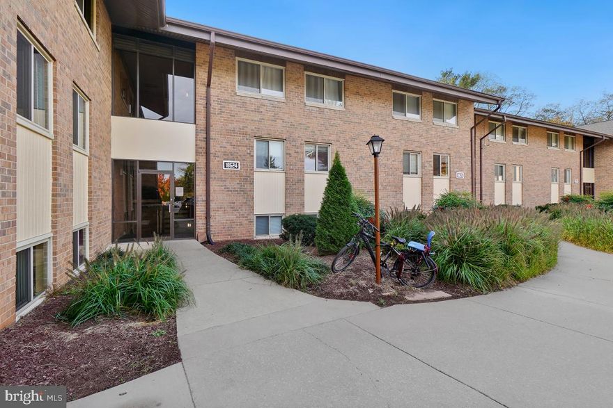 Step into the convenience and comfort of this inviting ground-level condo, ideally located within a short stroll of shopping, dining, and public transit. This 1-bedroom, 1-bathroom unit offers a harmonious blend of modern comforts and serene natural surroundings.

Inside, you'll find a sunken family room graced by high ceilings, floor-to-ceiling windows, and a sliding door leading to your private patio. From here, you can enjoy delightful views of the tranquil community common grounds and the surrounding treeline.

The dedicated dining room boasts durable luxury vinyl plank (LVP) flooring and provides a charming space for meals with a view. The eat-in kitchen is well-appointed with ample cabinetry, a gas range, and a convenient in-unit full-size front-loading washer and dryer.

The spacious primary bedroom offers room for a sitting area and features double walk-in closets for your storage needs. The full bathroom has been tastefully updated with modern fixtures and beautiful tilework details.

In addition to the in-unit storage closet, you'll appreciate the all-inclusive condo fee, which covers all your utilities, streamlining your budget.

Beyond your condo, the community provides a resort-like experience with amenities such as a pool, tennis courts, jogging/walking paths, and playgrounds. Embrace a lifestyle of convenience and leisure in this charming condo – reach out today to schedule a viewing and discover the tranquility and modern living it has to offer.