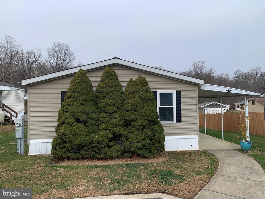 A Premium spot on the "lake" for this well kept 2 Bedroom, 2 Bath home in Village Green over 55  community. Ample living space and 2 en suite Bedroom/Bath layout. Lakefront Deck, Large Covered Patio, Shed and many recent updates. Spacious Living Room with vaulted ceiling & fan, Dining Area, Oak Kitchen with newer range, dishwasher & double sink, Front Bedroom with vaulted ceiling & fan, closet plus Full Bath including tub/shower combo & vanity,
Bedroom 2 with vaulted ceiling, lakeview sliders to rear Deck, entrance to Full Bath with vanity and shower & large walk in closet. Central Air, NEW Oil tank (2025), Newer Water Heater (2024), New range (2025), Newer screen door (2024), Newer Anderson windows (2022-2023), Newer Roof (2022), Newer carpets (2022). Come see this home before it goes, This one is the best! Views dont get any better than this. This is a manufactured home with ground lease.