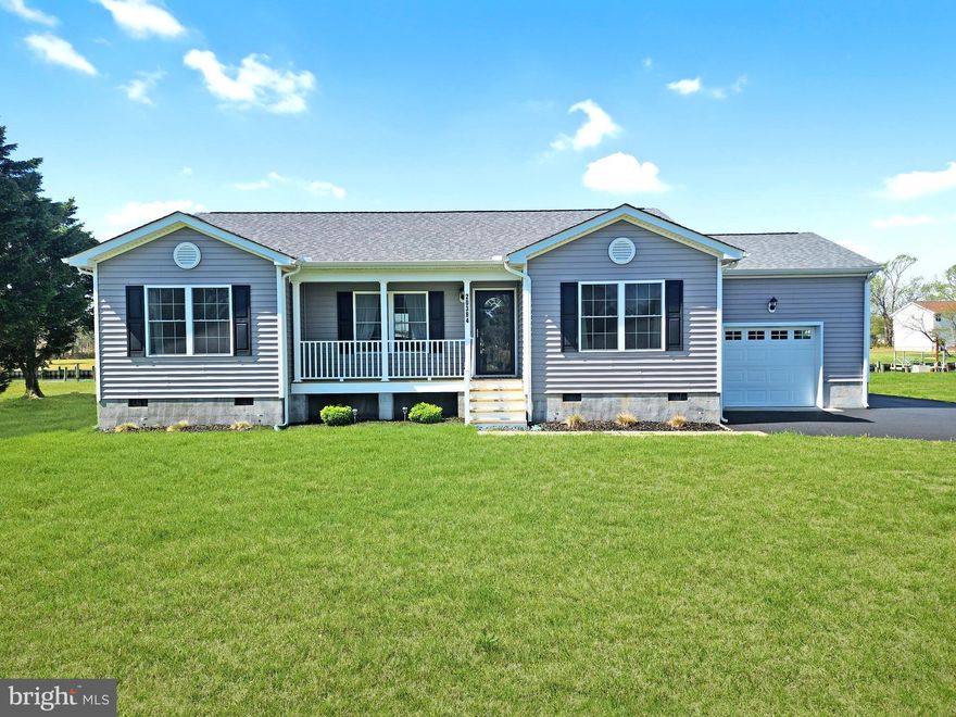 ***Coastal Oasis*** This single-level, like-new home might be exactly what you've been looking for and situated on almost a half-acre waterfront lot with over 100' of bulkhead. The spacious open floor plan flows through the living room, into the dining area, and into the kitchen. The countertops are a beautiful granite accented by Stainless Steel appliances. The sliding door off the dining area leads you to a large patio overlooking the peaceful canal. On one side of the house, you will enjoy a private primary suite with a walk-in closet and private bath. Across the great room are two more bedrooms and another full bathroom. Through the kitchen, there is a large laundry/mudroom that leads to the attached garage. Home is equipped with a water softening system, a hook up is installed for a whole house generator and there is a Rain Bird automated sprinkler/irrigation system installed throughout the front and backyard. It is timer controlled and offers access to change settings from an app on your phone. Furnishings are negotiable.