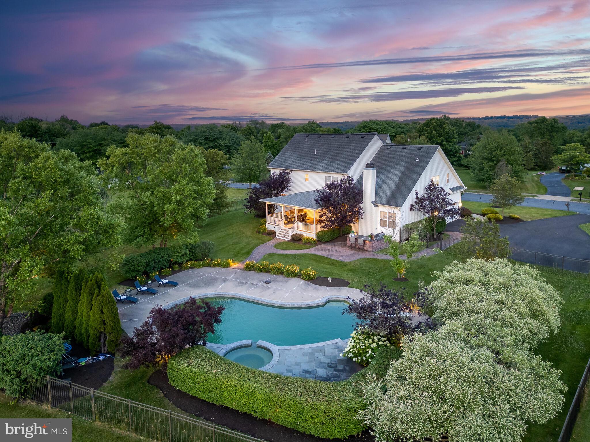 Beautiful, stately, brick-front colonial with 4 bedrooms, 3.5 bathrooms with approximately 4,333 square feet of living space on the first and second levels. The large, fenced-in backyard oasis features a newly renovated in-ground swimming pool and a large outdoor entertaining area in the highly desirable community of Country Ridge Estates in Plumstead Township! The property is set on a premium 1.75 acre private lot.
Step into the grand, light-filled foyer with a sweeping, open staircase and spacious entry ways into a gracious living, dining, and cozy sitting room. The sitting room is adorned with French doors, perfect for use as a second office, playroom, or relaxation space. The other side of the foyer features a convenient office with French doors providing an ideal private workspace, accompanied by a nearby powder room with hardwood floors.
The heart of this home is the beautifully updated kitchen, boasting white 42" cabinets, sleek granite countertops and modern stainless steel appliances, including a gas range, built-in microwave, dishwasher, and refrigerator. A half wall with matching white cabinetry and granite countertop separates the eating area from the family room, providing additional storage and entertaining space.
The inviting family room features a vaulted ceiling, brick gas fireplace with remote control and a convenient back staircase to the second floor. French doors off the kitchen lead to a covered porch above an exotic wood deck with ceiling fans and lighting and offers a perfect escape from the sun as well as a lovely outdoor dining and relaxing space. There is an extensive pool deck, complete with an Anthony Sylvan pool, spa, and diving board which has been recently renovated and is positioned perfectly to maximize the exceptional views. The lush, low-maintenance landscaping and abundant lighting create a magical setting for nighttime gatherings. A built-in grill, granite bar and sink enhance the ultimate outdoor entertainment experience.
Upstairs, the luxurious main bedroom suite serves as a private retreat, complete with a spacious walk-in closet and a recently renovated bathroom. There you will find a luxurious soaking tub, frameless tile shower, separate water closet, and dual-sink vanity. A guest suite with a full bath, along with two more bright and airy bedrooms sharing a hall bath, complete the upper floor.
The lower level is an entertainer's dream, featuring a media room, game room and a custom granite-topped wet bar, dishwasher, refrigerator, with beautiful wood cabinetry.
This home is conveniently located just minutes from Doylestown, the Septa train station, major commuter highways, and close to New Jersey. It resides in the highly-rated Central Bucks School District, with the grade school conveniently situated next to Country Ridge.
Please note: Public records indicate septic and private well; however, the home has public sewer and private well. There are 3 full baths, not two.
Experience the perfect blend of elegance, comfort, and convenience at 4693 Ridgetop Road. Welcome home!