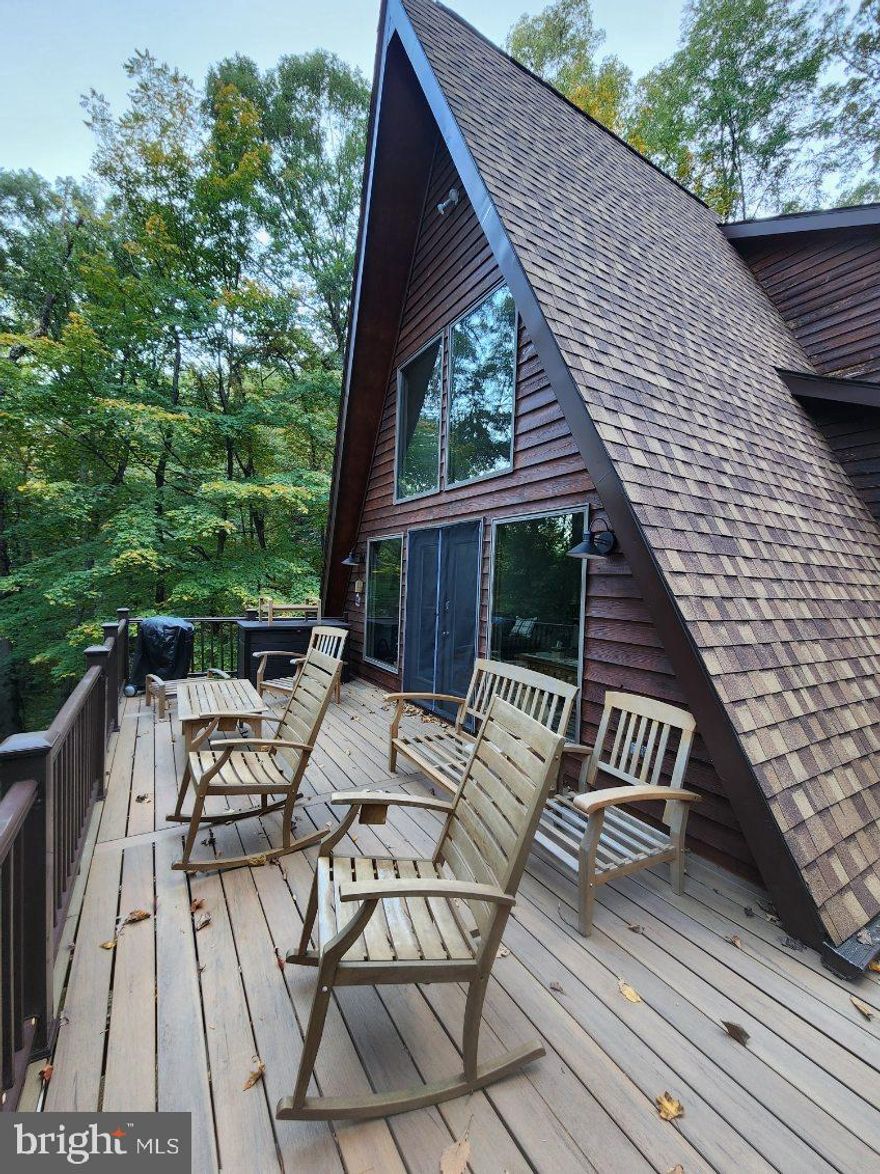 Awesome home in Coolfont Mountainside with 5 bedrooms, 5 full baths, a great room, cathedral ceilings and plenty of windows for all the light.  A spacious modified A-frame that features a wood stove.  Central heat and air and a new roof are also nice features.  Covered porch, a walkout basement, and a rear deck round out the package. Close to Cacapon State Park and downtown Berkeley Springs.  Community features it's own pool, hot tub, tennis courts, playground, hiking trails, and much more.

2021 New house signs installed at end of driveway
2021 Architectual Roof Installed - 50 year along with new rainspouts and downspouts
2021 Underground drains installed to dispurse water from downspouts
2021 LVP flooring installed throughout
2021 All interior rooms and trim painted
2021 Concrete patio added - lower level
2021 All interior ceiling lights replaced
2022 4 tons dirt added to level side of house and around back patio
2022 Entire house power washed and stained
2022 Exterior Doors painted
2023 Foundation painted
2023 Deck replaced with Timbertech along with new railings
2023 Outside deck and porch lighting updated
2024 Ceiling fans installed in Master Bedroom and 2 upstairs bedrooms
2024 Toilets replaced in lower level bathrooms